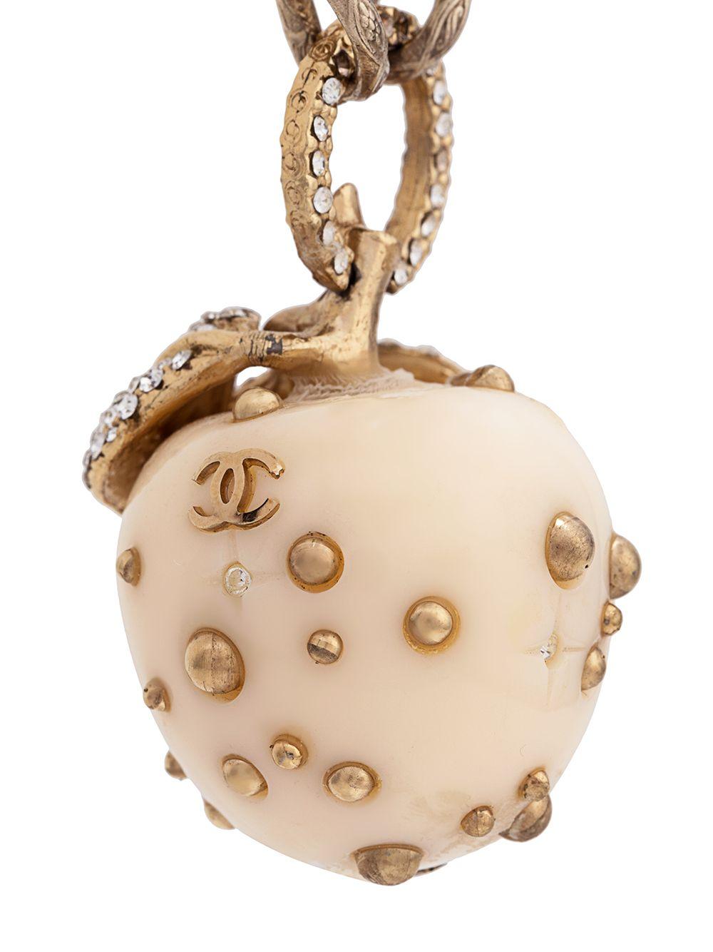 Brimming with romance and sweet femininity, this elegant, statement-making necklace from Chanel is a unique piece that adds a touch of classic sophistication to any outfit. Crafted from an intricate combination of cream-coloured PVC, gold-toned