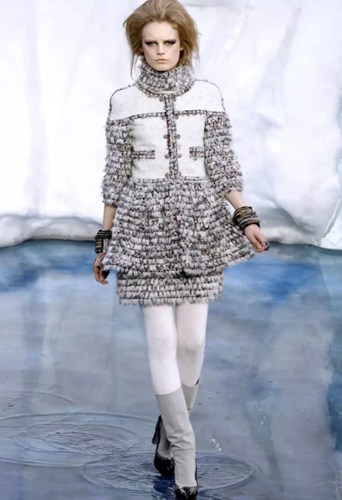 From Chanel’s Arctic-inspired Fall/Winter 2010 runway collection, this rare sample dress designed by Karl Lagerfeld is a striking collector’s piece. Crafted in off-white felted wool, the A-line mini silhouette features an elevated boucle turtleneck