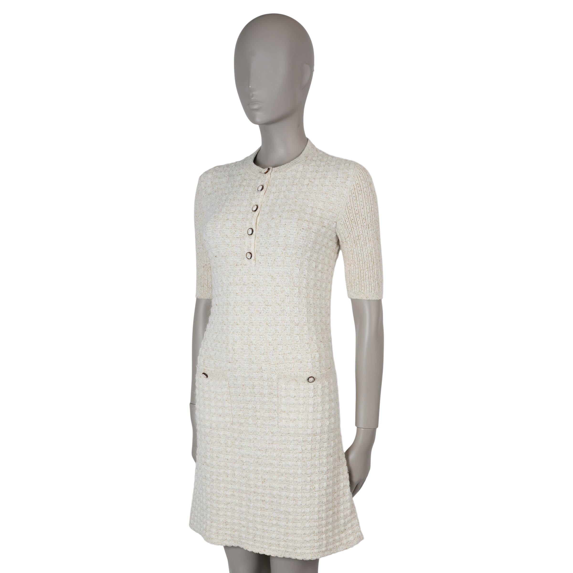 This 100% authentic Chanel lurex knit dress is crafted from a luxurious blend of beige, cream, and gold viscose (66%), polyester (22%), nylon (6%), mohair (4%), and wool (2%). It features a fitted top with a flared skirt, rib-knit crewneck, short