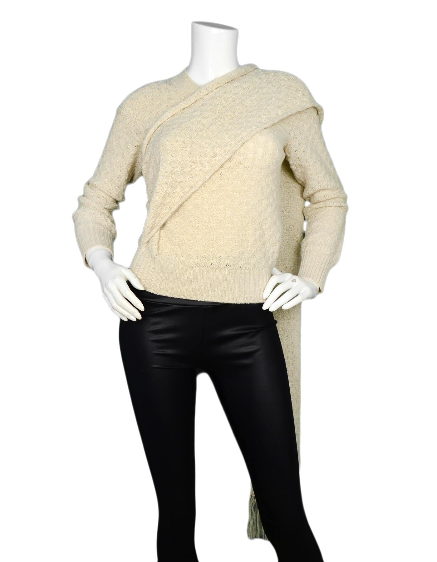 Chanel Cream Knit Sweater W/ Attached Scarf Sz 38

Made In: Italy
Color: Cream with gold sparkle
Materials: 75% alpaca, 20% rayon, 5% polyester
Opening/Closure: Pull over
Overall Condition: Excellent pre-owned condition with excpetion of a couple of