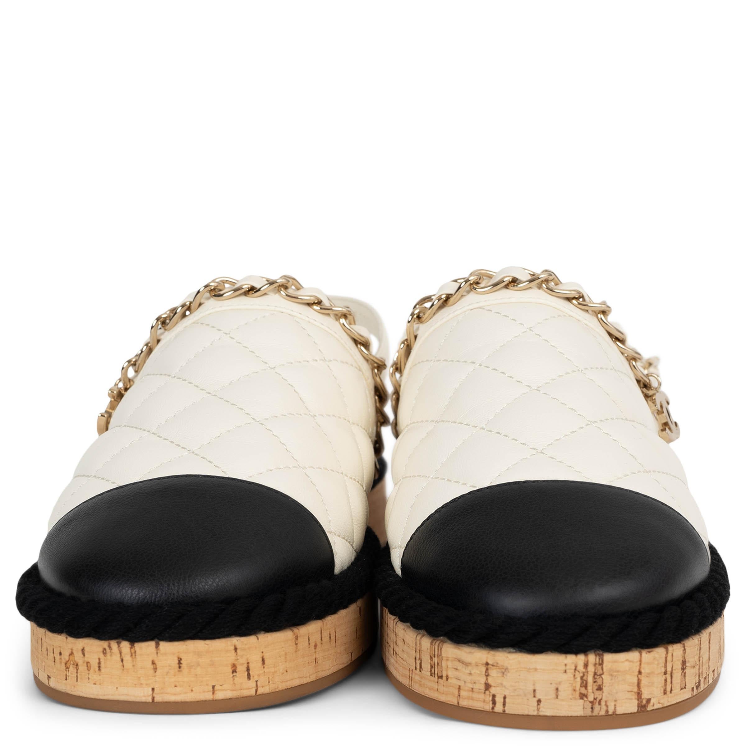 100% authentic Chanel slingback mules in white quilted calfskin leather. Feature rounded toes with contrasting black toe caps, black cord trim, and signature leather-interwoven chain detail with a dangling CC charm across the top. Fasten with a