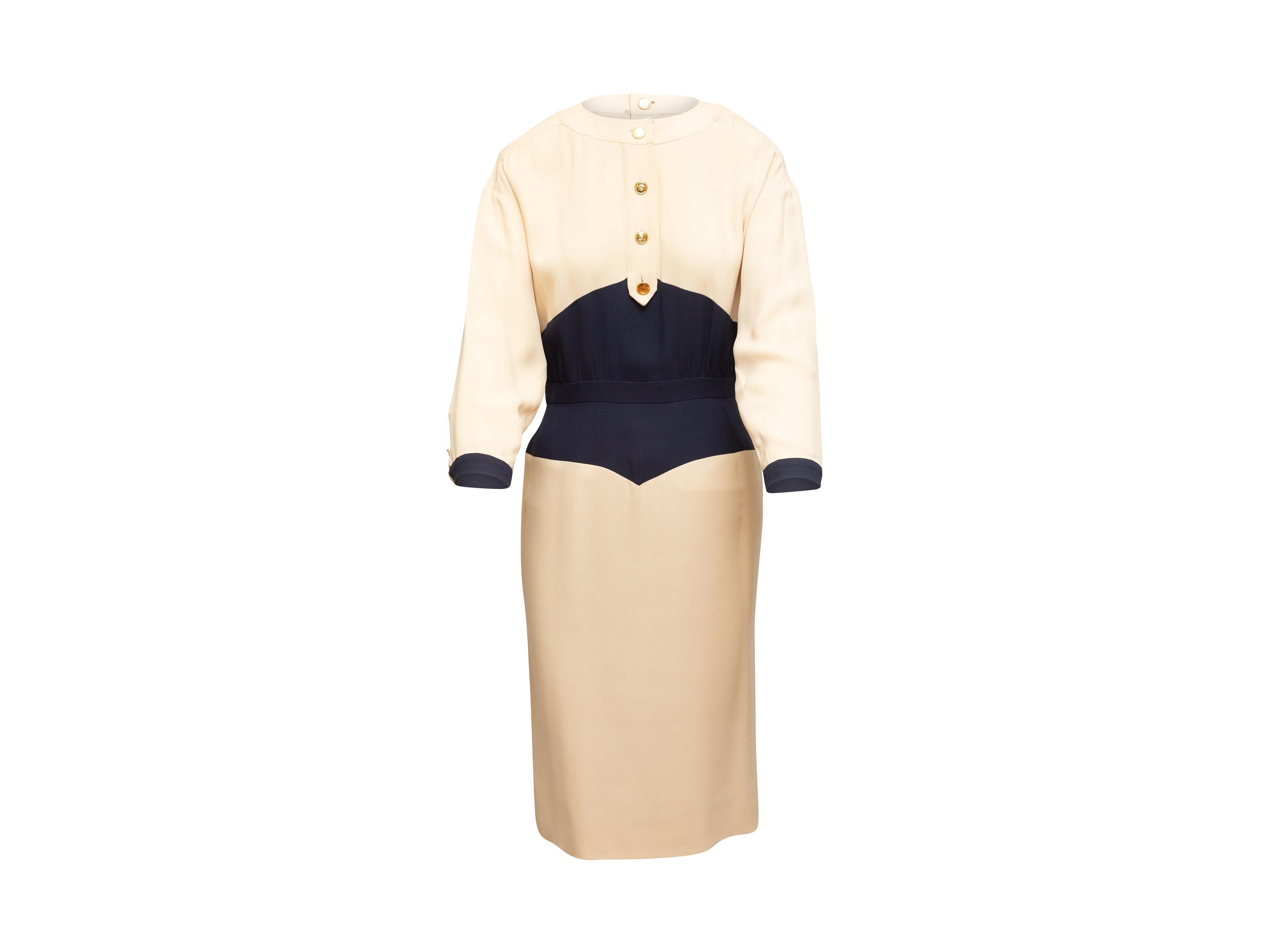 Product details: Vintage cream and navy long sleeve dress by Chanel Boutique. Crew neck. Buttons at front bodice. Zip closure at center back. 38