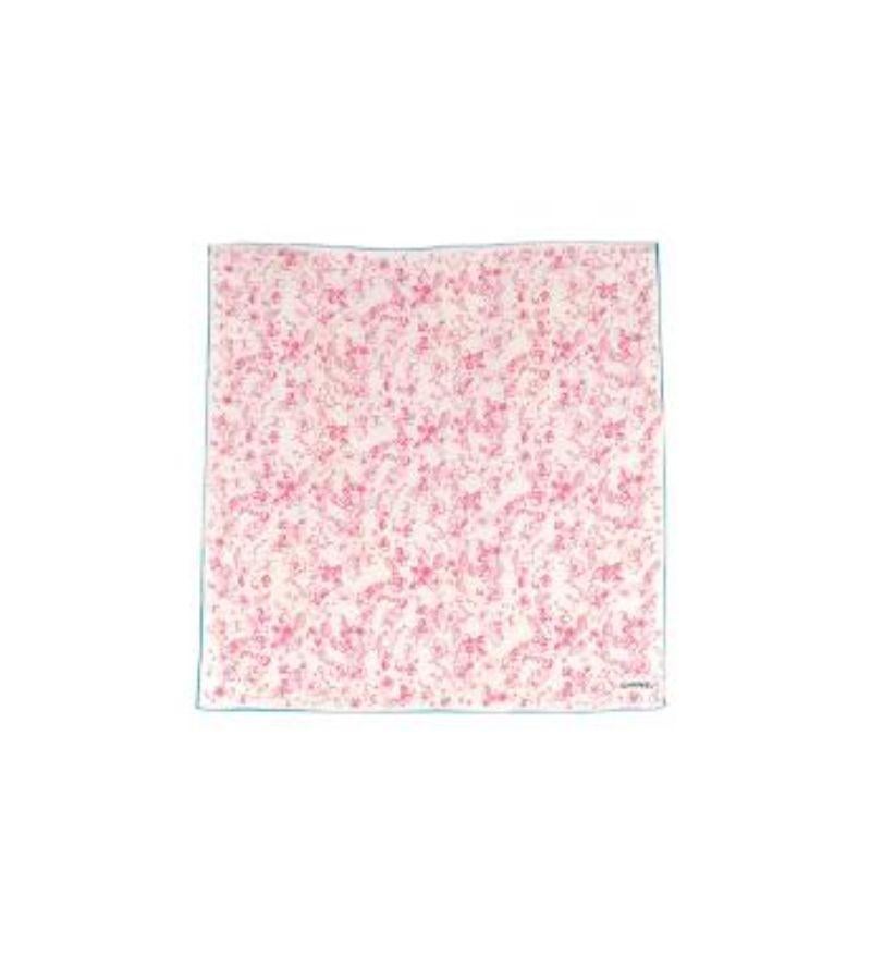 Chanel Cream & Pink CC Floral Scarf 

-Pink floral pattern with bows, floral and chanel logos
-Cream background and turquoise border 
-Square 
-'CHANEL' lettering right bottom corner in bold black letters

Material
-Silk

Washing
-Dry clean only