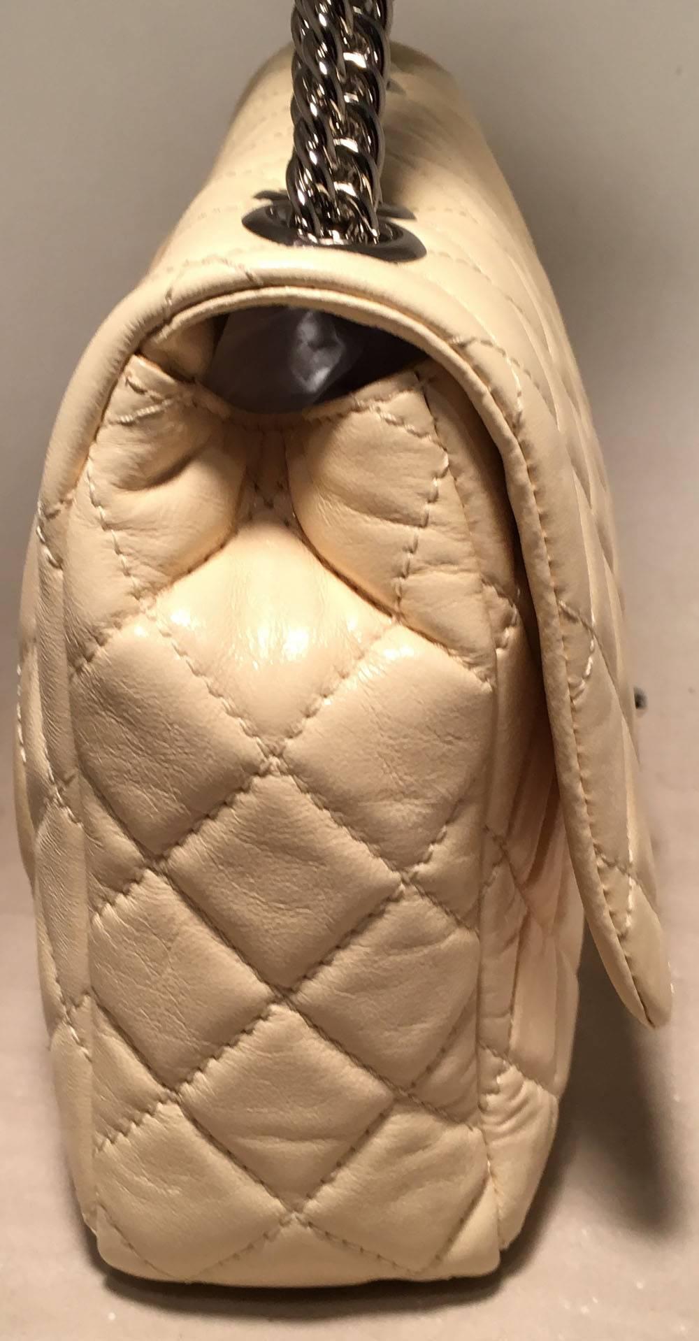 GORGEOUS Chanel quilted cream leather classic flap shoulder bag in excellent condition. Quilted cream lambskin leather exterior trimmed with silver hardware and snake chain shoulder straps. Twist CC logo front closure opens via single flap to a