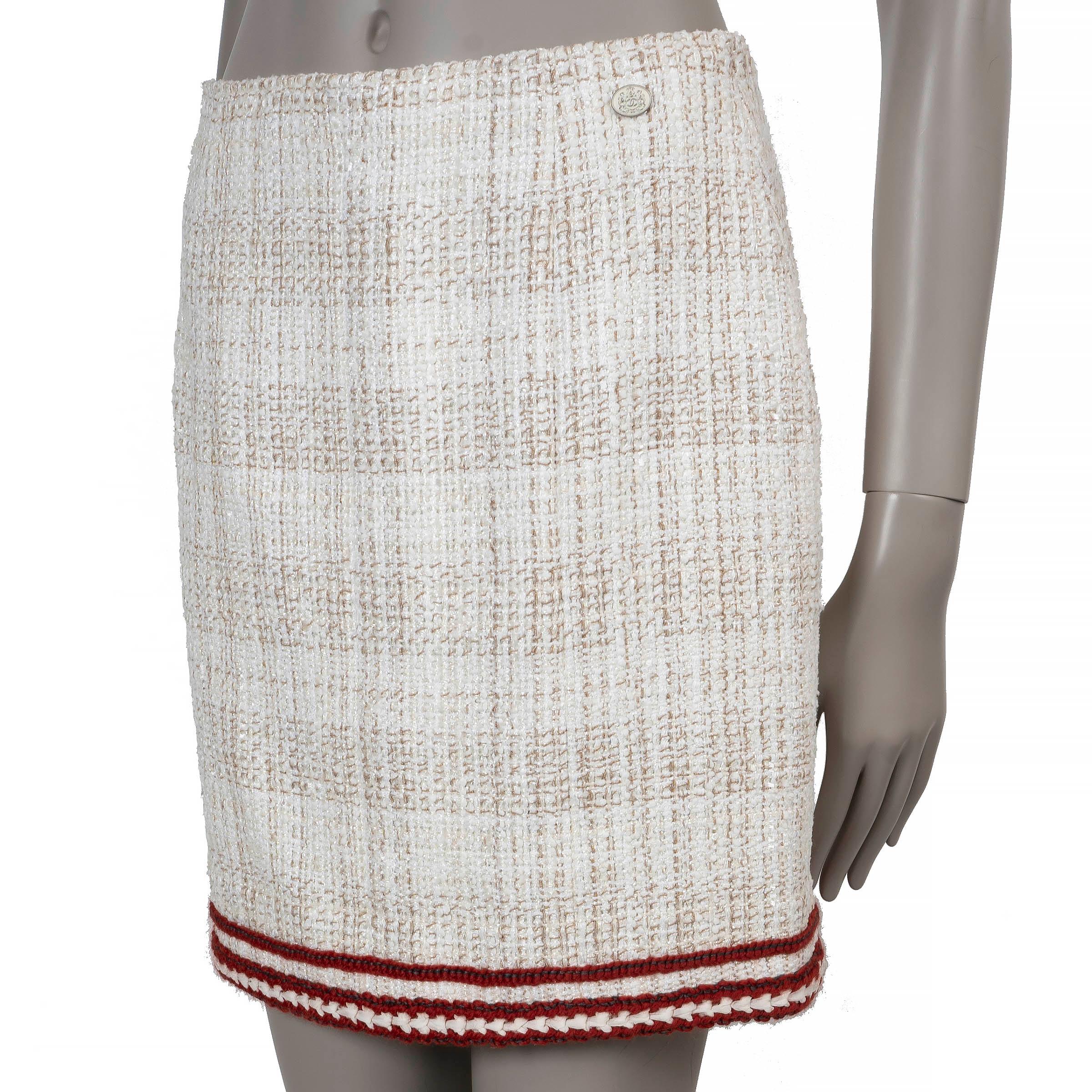 This 100% authentic Chanel mini skirt in cream and beige tweed embodies timeless elegance with a playful edge. Crafted from a luxurious blend of cotton (33%), acetate (27%), polyamide (23%), and polyester (17%), it features a flattering high-waist