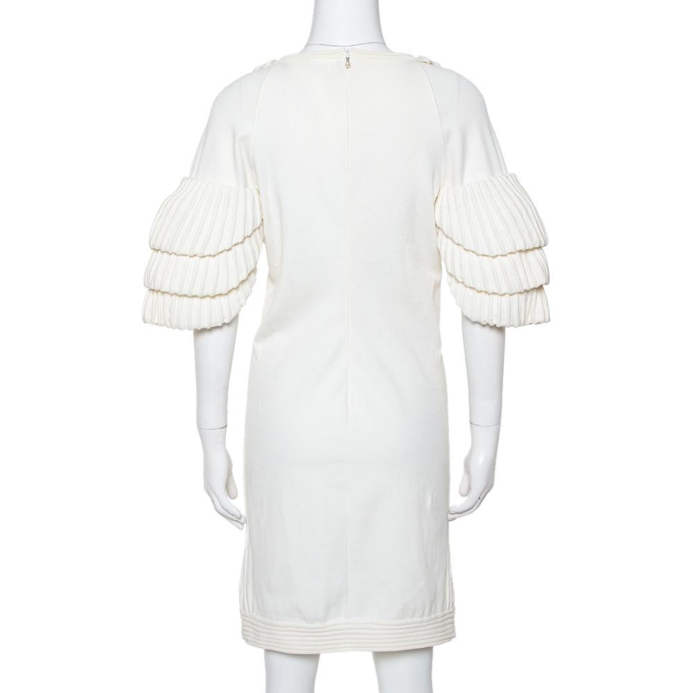 Make a dazzling style statement with this chic dress from Chanel. Designed to beautify, this cream piece is ideal for parties or grand events. Tailored from a cotton blend in rib knitting style, this stunning dress comes with a beautiful neckline