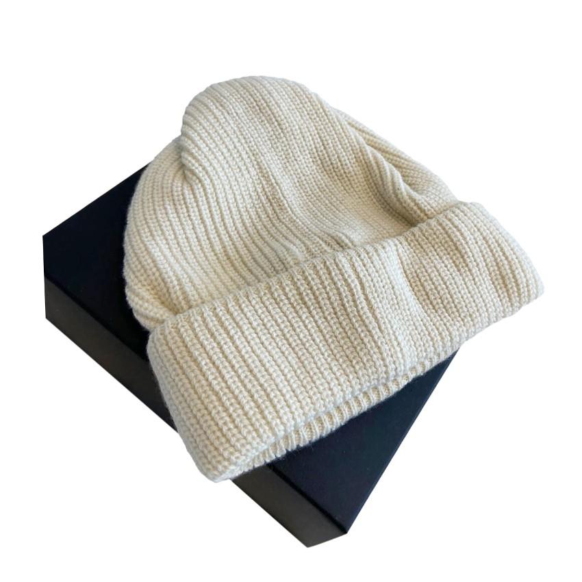 Chanel Cream Ribbed Cashmere Beaded Logo Beanie
 

 - Ribbed cream cashmere beanie
 - Black faux pearl-embellished Chanel lettering at the front
 - Turn-up hem
 

 Materials:
 100% Cashmere
 

 Made in Italy
 Dry clean only
 

 PLEASE NOTE, THESE