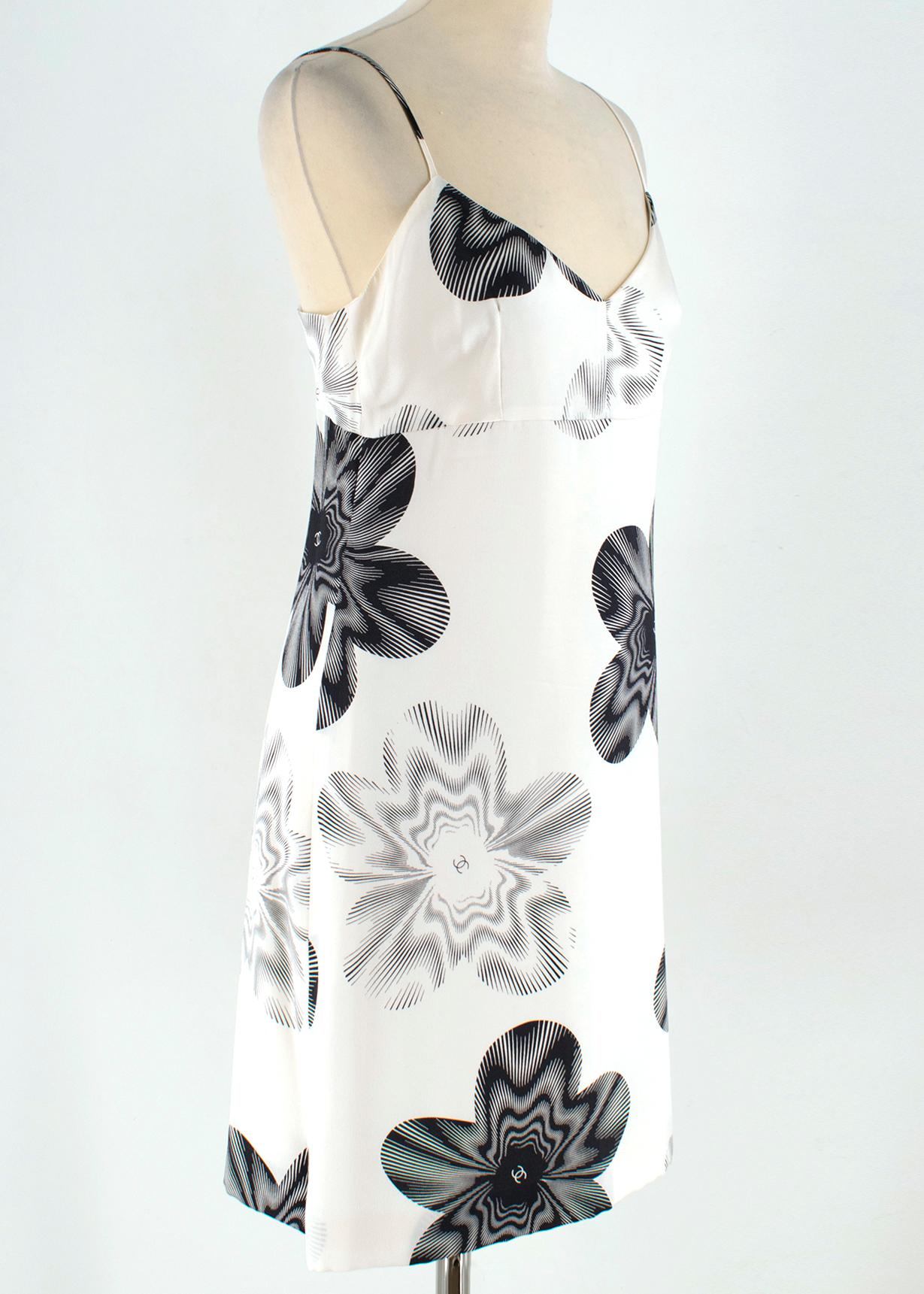 Chanel Cream Silk Floral Patterned Slip Dress 

- Silk cream slip mini dress with contrasting floral CC pattern
- V- neck
- Back zip & button closure 
- Made in France
- Fully Lined

Please note, these items are pre-owned and may show signs of being