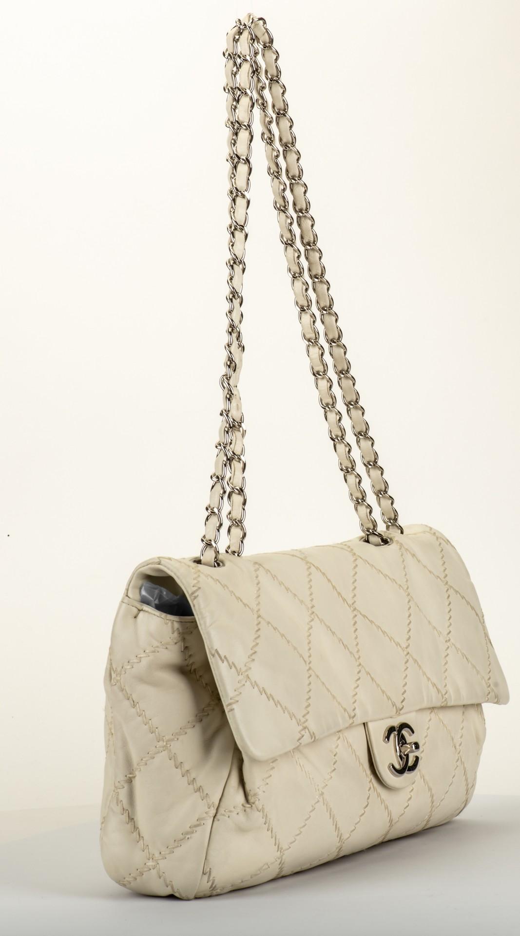 Chanel cream stitched jumbo flap with silver tone hardware. Shoulder drop 12