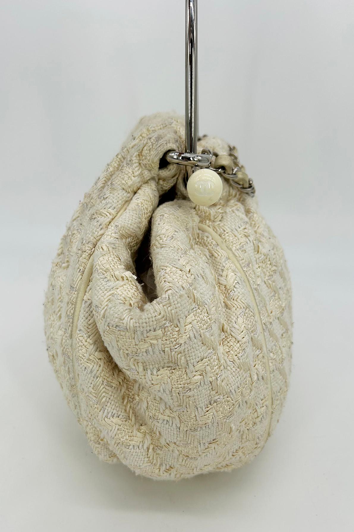 Chanel Cream Tweed Boucle Knitting Bag in good condition. Cream woven boucle tweed exterior trimmed with silver hardware and signature woven leather and chain handle. Unique knitting bag design with a round body and gathered top closure which