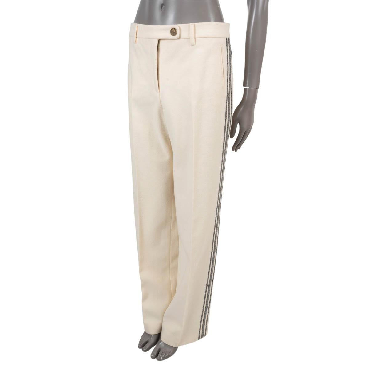 100% authentic Chanel pants in off-white wool (80%) and alpaca (20%). Feature side stripes in grey, a high-rise, wide legs, two slit pockets and a pocket on the back. Closes with a button and concealed zipper on the front. Lined in silk (100%). Have