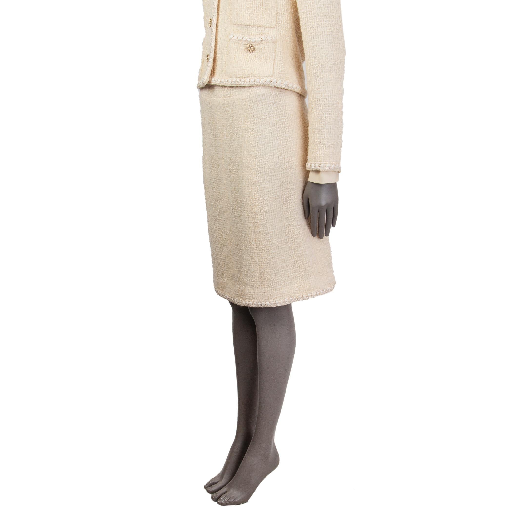 Chanel boucle skirt in cream and off-white wool (70%), silk (8%), mohair (8%), nylon (1%), and rayon (1%). With crochet trims. Closes with hook and invisible zipper on the back. Lined in cream silk (100%). Has been worn and is in excellent