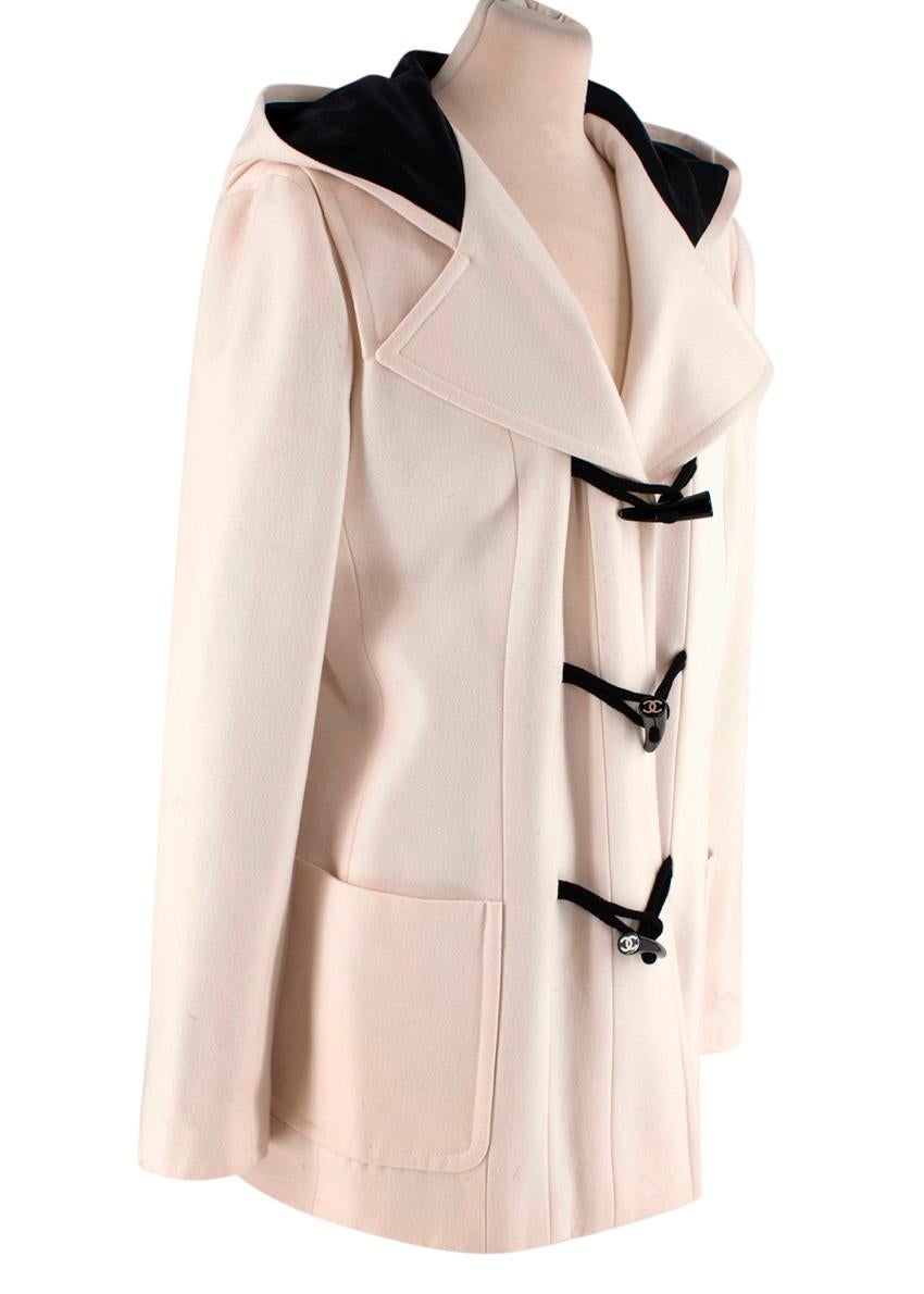  Chanel Cream Wool Duffle Coat
 

 - Classic duffle coat, given a Chanel makeover- feauturing super-soft wool cloth in a warm cream tone, and CC logo embellished horn toggle fastenings 
 - Hooded, long sleeve style, with delightful seam back detail
