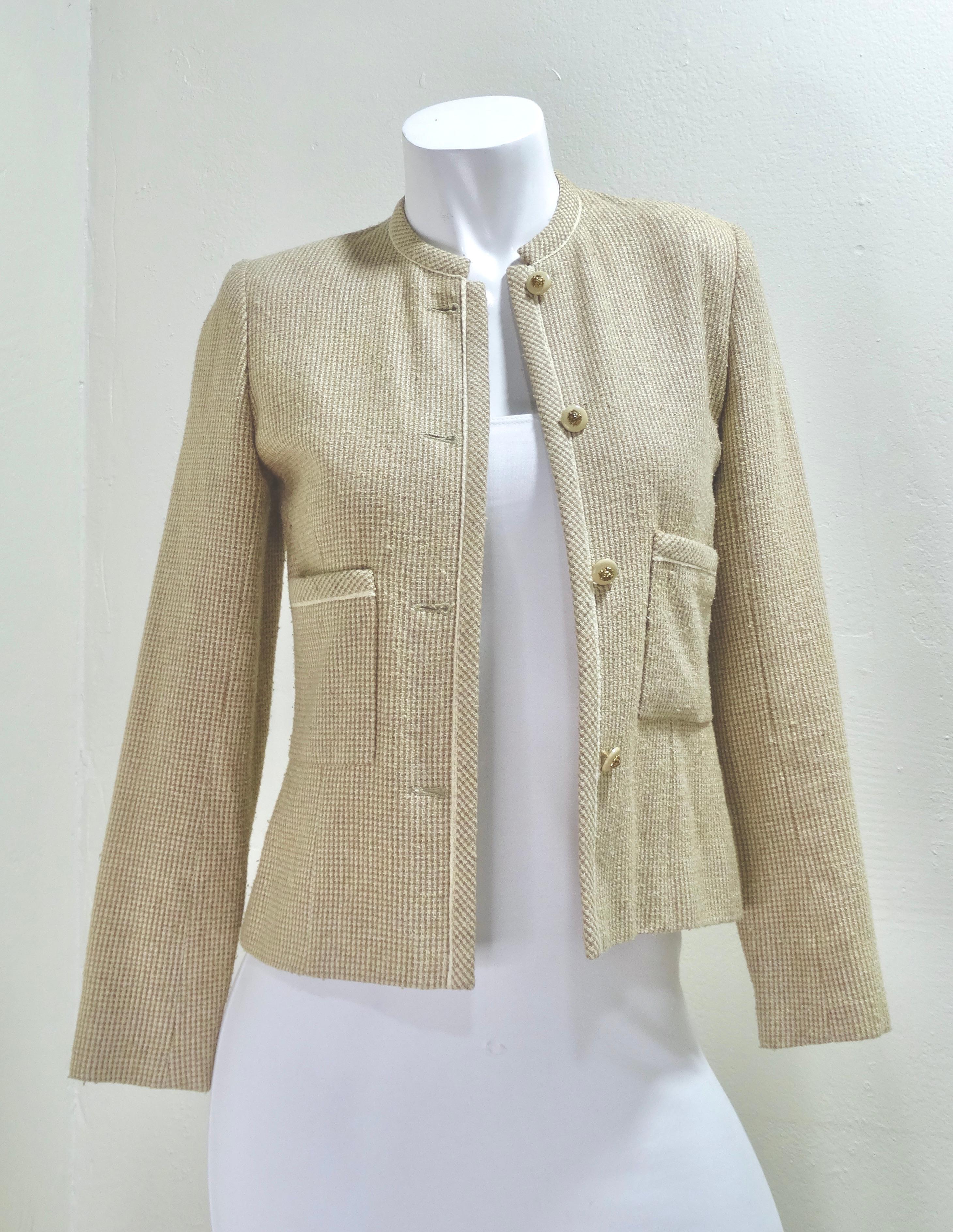 A true Chanel Collectors vintage piece straight from the 1980's! This beige color is perfect for everyday wear and will match every color in your closet. This jacket features a beige and white woven tweed, two front pockets, four beautifully