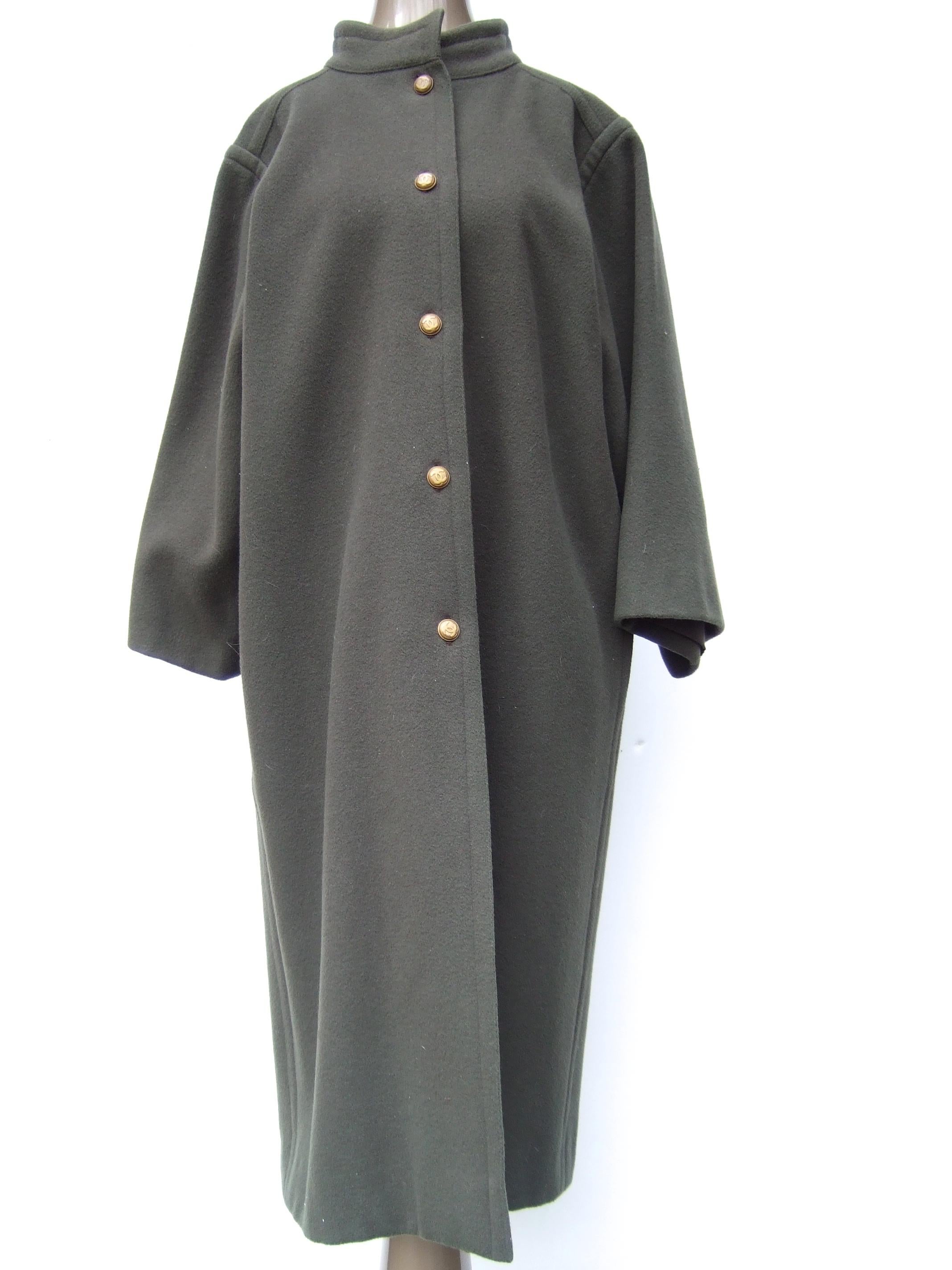 CHANEL Creations muted gray - green wool coat with C.C. buttons c 1980s
The stylish winter gauge wool coat is designed with a rounded stand-up collar
Adorned with five burnished brass metal buttons with Chanel's C.C. interlocked
 initials 

Designed