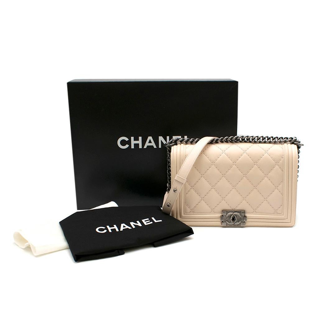 Chanel Creme Blush Quilted Leather Medium Le Boy

Pink quilted design Chanel boy bag
Features flap 
Calfskin leather lining 
Silver chain strap detailing 
Silver squared CC press lock
Zippered interior pocket
Grey interior lining

Dust bag and box