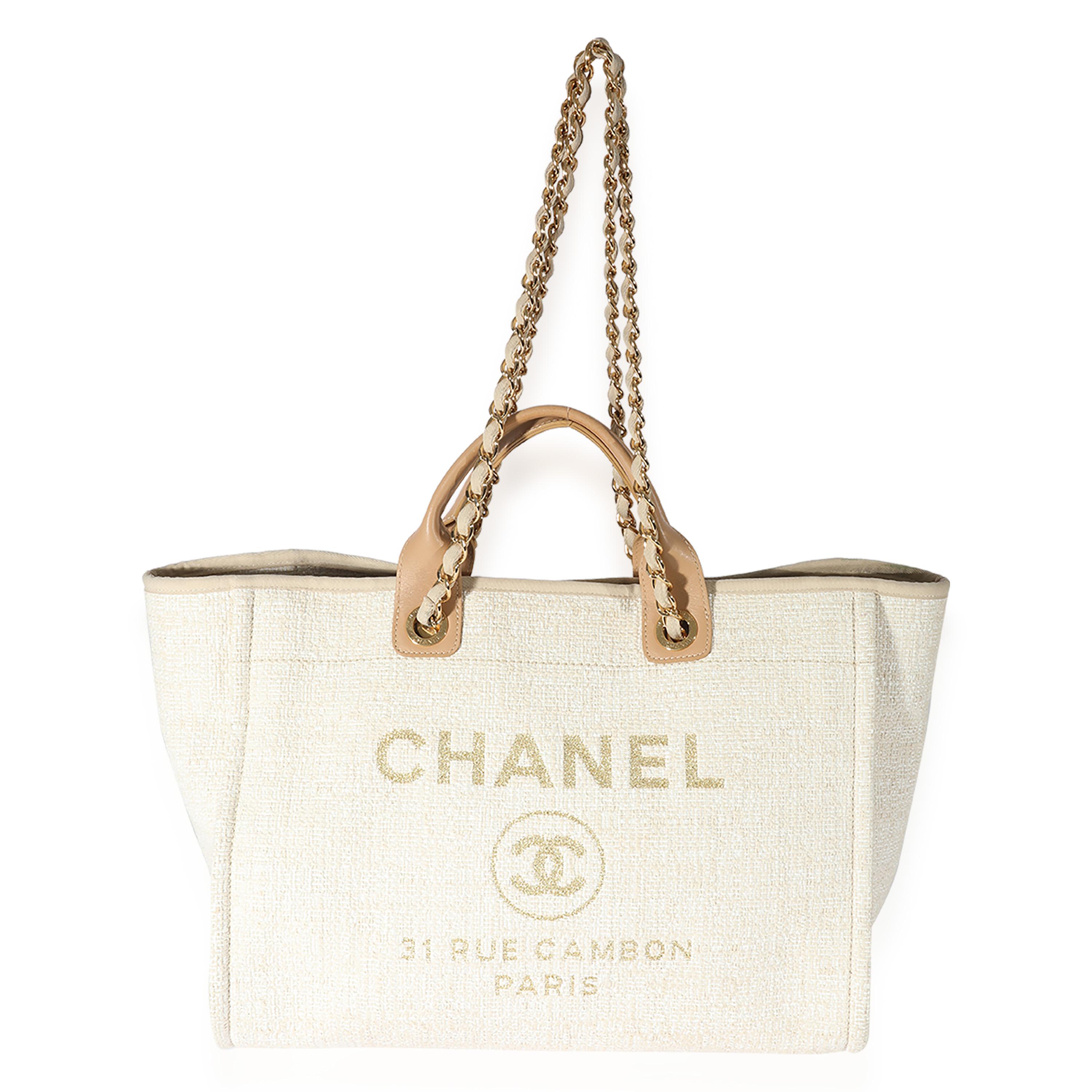 Listing Title: Chanel Creme Canvas Large Deauville Tote
SKU: 126288
Condition: Pre-owned 
Handbag Condition: Very Good
Condition Comments: Very Good Condition. Light scuffing, discoloration at straps and at exterior. Scratching at hardware.