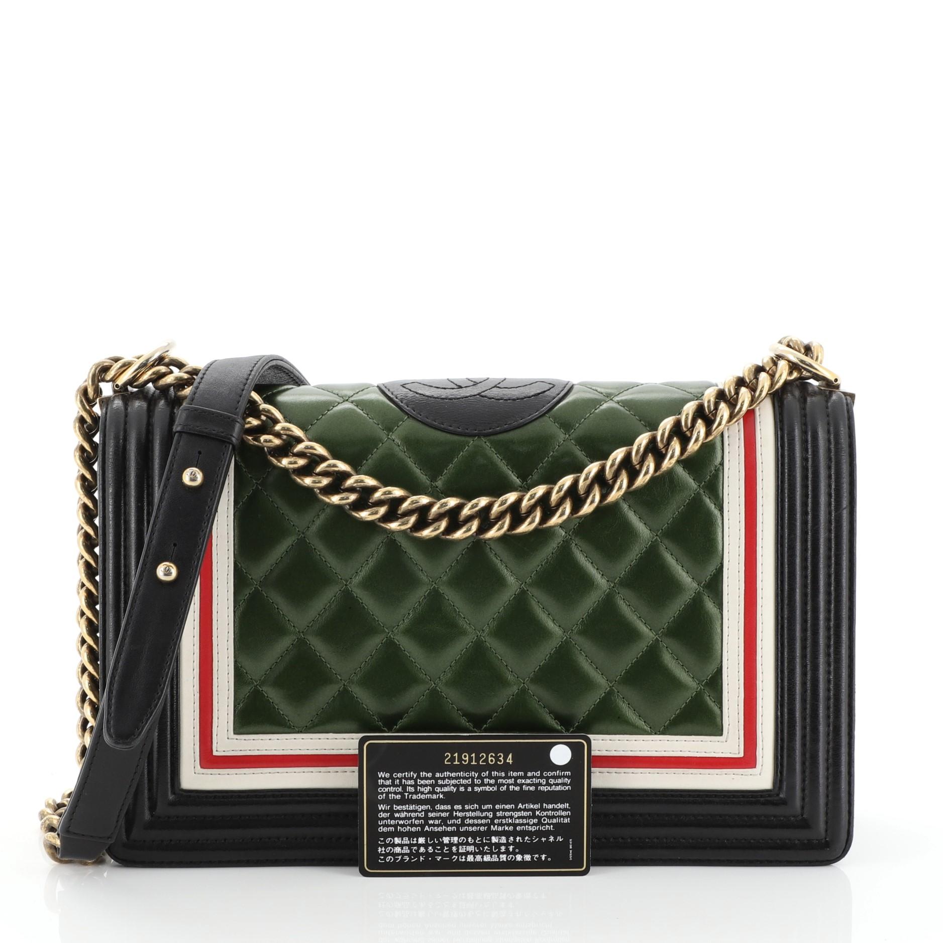 This Chanel Crest Boy Flap Bag Quilted Lambskin New Medium, crafted from green multicolored quilted lambskin leather, features chunky chain link strap with leather shoulder pad, red and white border trims and aged gold-tone hardware. Its CC Boy logo