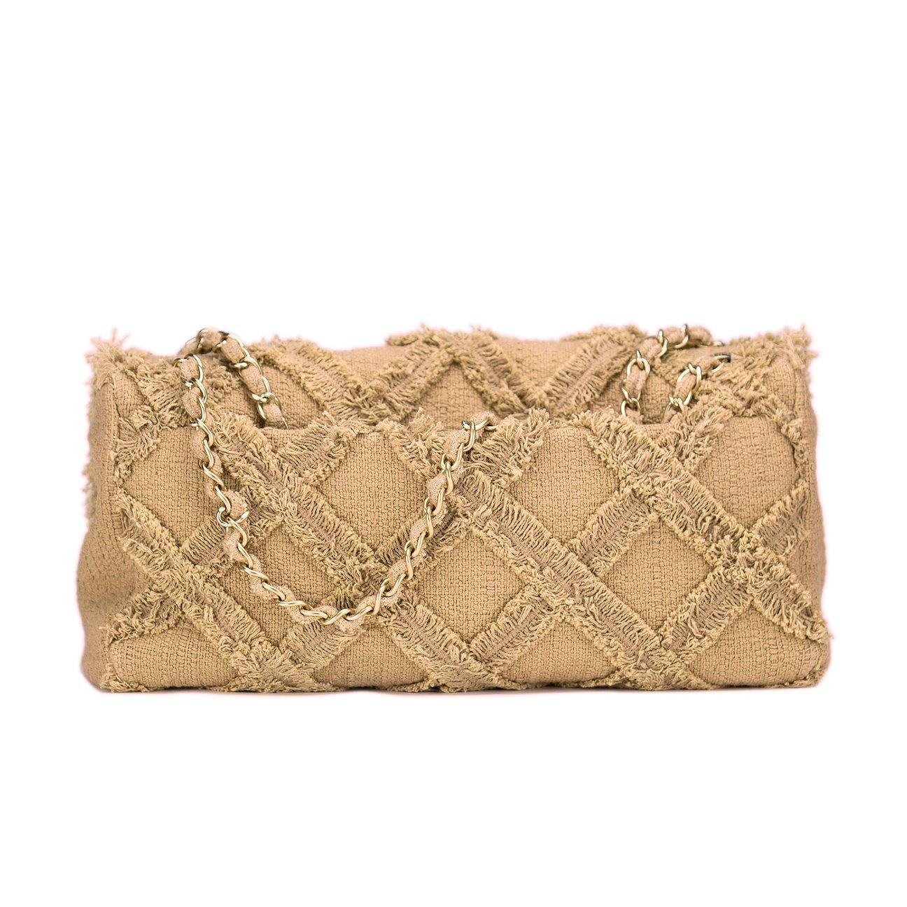 Chanel extra large sized beige tweed crochet flap

2009
Antique gold hardware
Large CC logo
Magnetic clasp closure
Interior beige canvas lining
Interior center zippered pocket
Two additional interior open pockets
Interior leather key chain