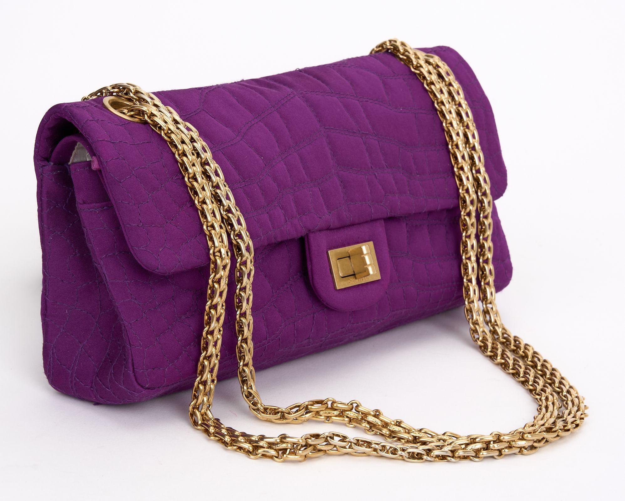 This Chanel Purple Crocodile Embroidered Satin 2.55 Reissue Double Flap Bag features brushed gold hardware and embroidered satin with purple interior and a turn lock closure. Comes with dust cover. Hologram First Two Numbers are 11. Strap Drop- 10