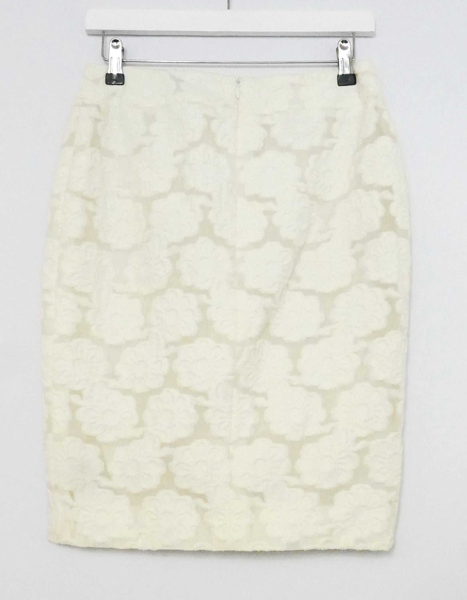 Absolutely gorgeous, modern feminine skirt from the Chanel Spring Cruise 2009 collection. Worn just once and then carefully stored. Made from semi sheer cream Camelia floral flocked cotton and polyamide with a full silk lining and concealed back