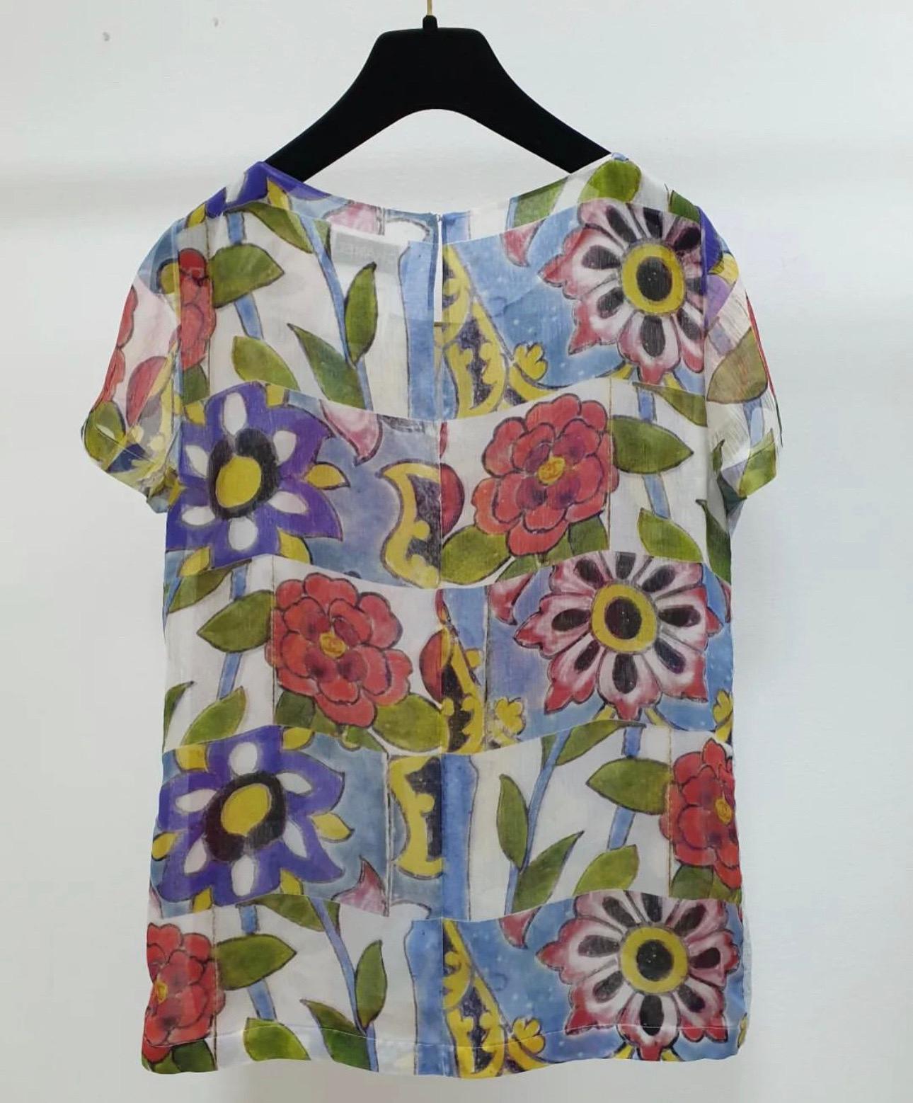 Chanel Multi Color Silk Floral Print Blouse. 
This beautiful Chanel blouse  is in excellent condition. 
There is no sign of use. It is made of 100% silk and has a colorful floral print throughout.  
Sz.38
Hanger is not included