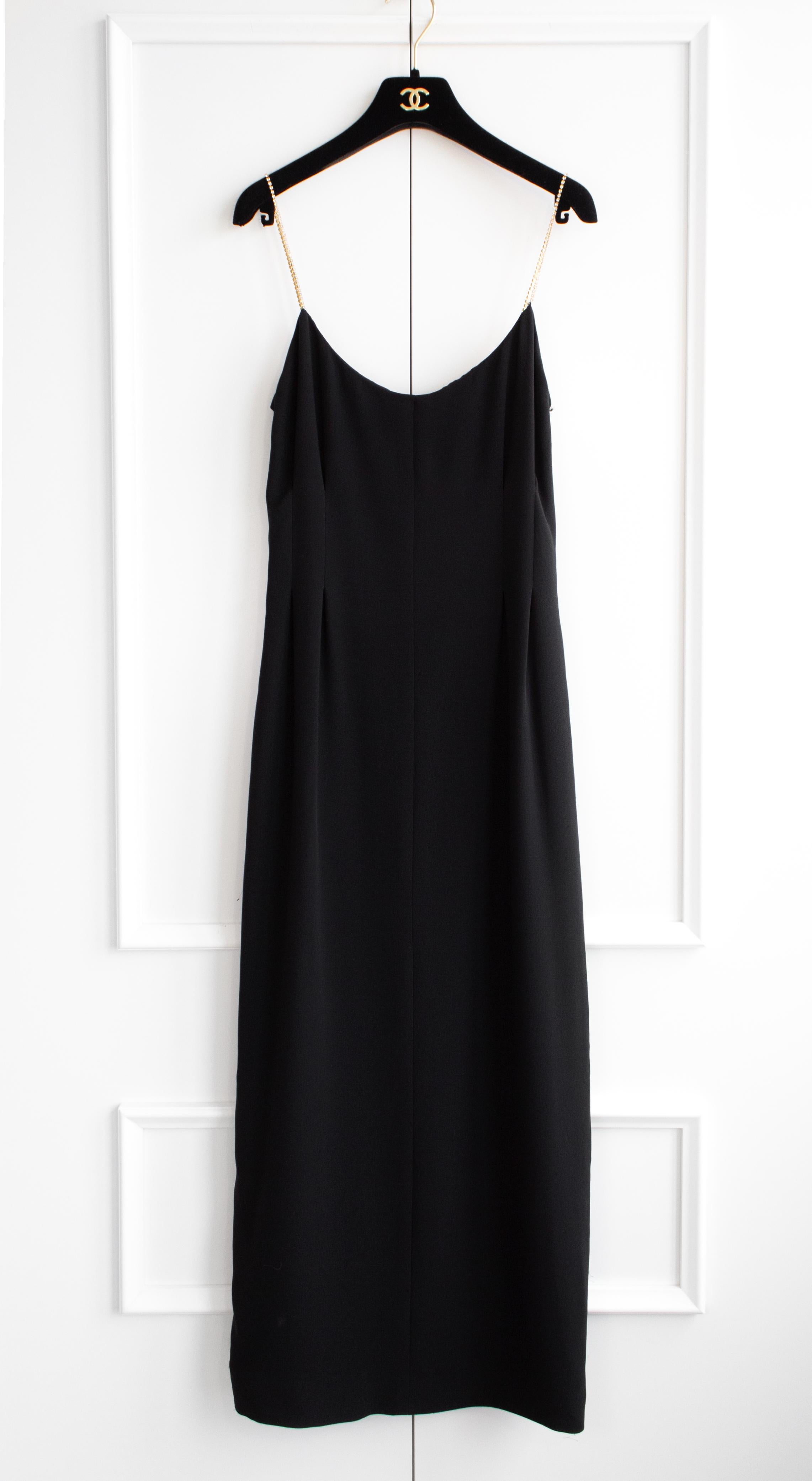 Introducing a timeless piece from the Chanel Cruise 2015 collection: the classic little black dress. This fitted sleeveless midi dress exudes elegance, featuring sparkly crystal-embellished straps that add a touch of glamour to its sophisticated