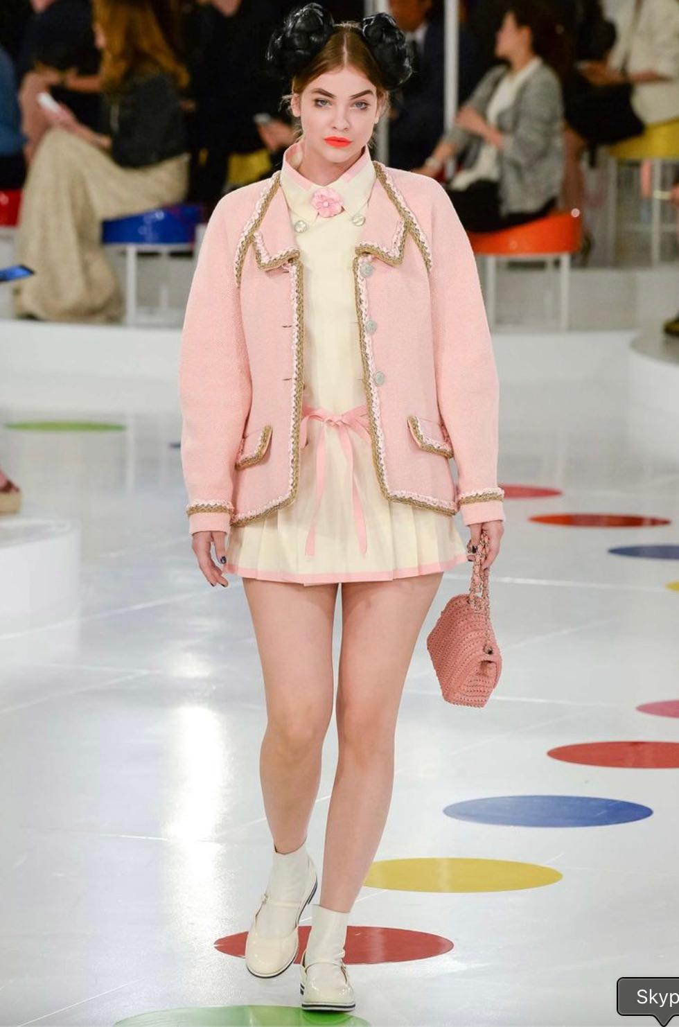 This soft pink cotton tweed jacket from the Chanel Seoul Cruise Collection is a stunning and rare collector's piece. Drawing inspiration from the traditional Korean Hanbok, its silhouette embodies elegance with a modern touch. The jacket is adorned