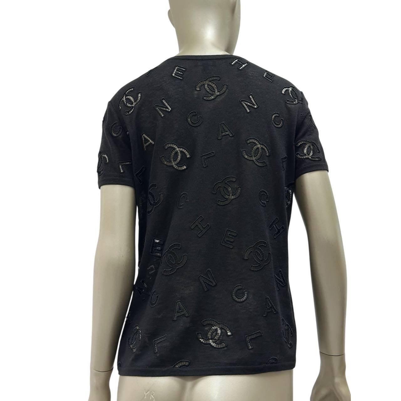 Elevate your wardrobe with this chic Chanel T-shirt from the Cruise 2020 Collection, designed by Virginie Viard.

Crafted in classic black, this T-shirt features the iconic interlocking CC logo with embroidered accents, adding a touch of luxury to