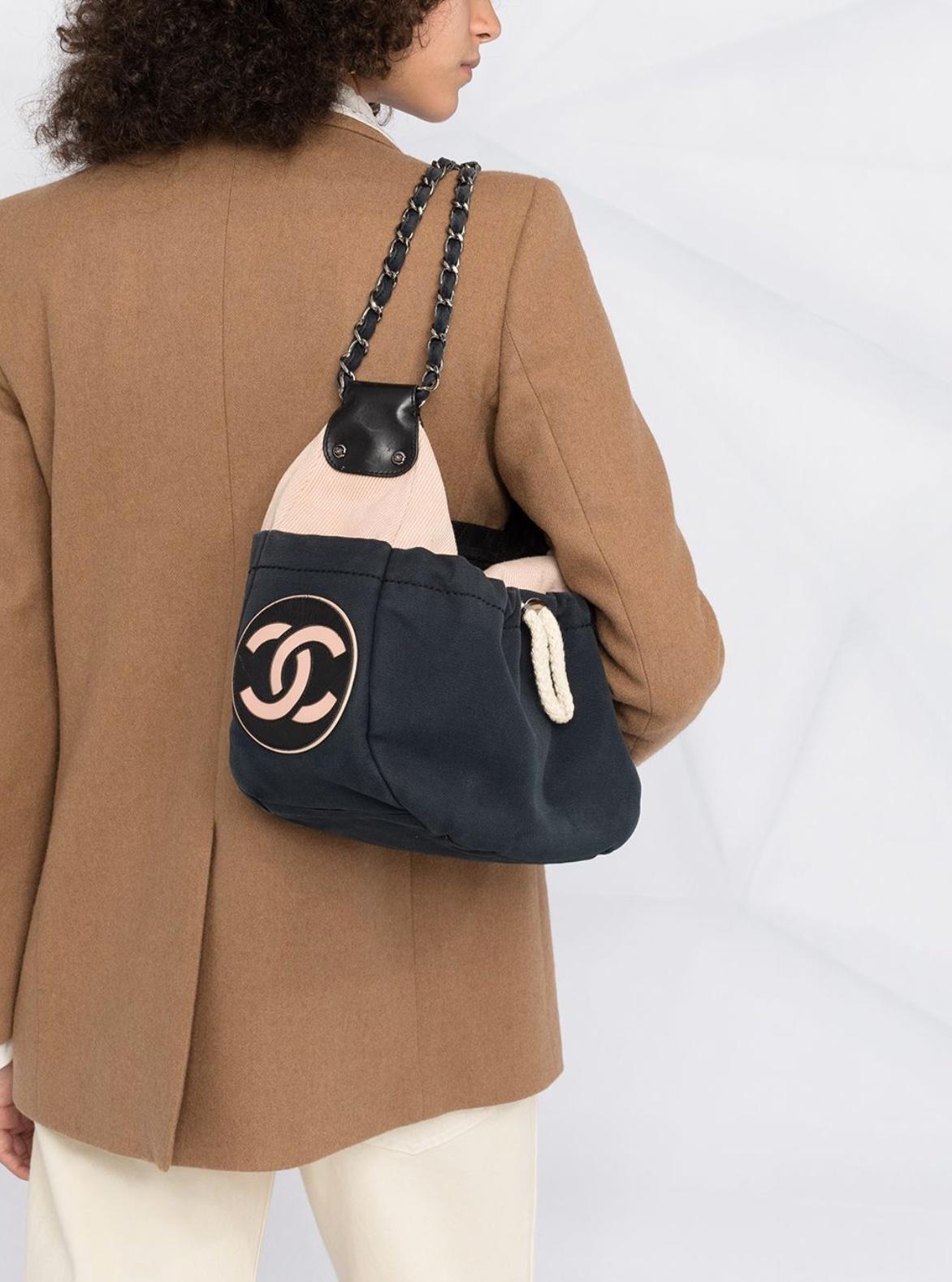 Chanel Cruise Sailing Yacht Boating Rope Cotton Pochette Hobo Shoulder Bag 

Year: 2004

This nautical drawstring style shoulder bag features quilted leather around the zipper, two classic silver and canvas interwoven shoulder straps, and a CC logo