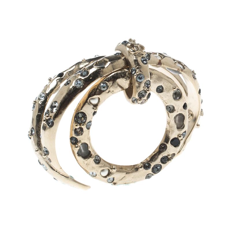 Artfully made from gold-tone metal, this flawless bracelet by Chanel can be your next prized possession. Featuring crystal embellishments and a ring charm, this open cuff piece is simple and grand.

Includes: Original Box, Price Tag, Info Booklet

