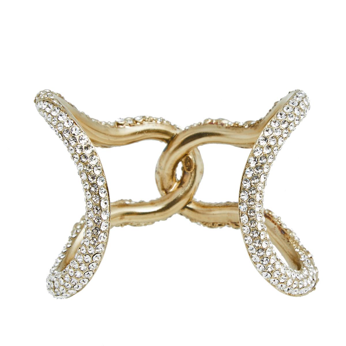 Constructed using gold-tone in an open cuff design, this Chanel bracelet is sure to fit well and look great on your wrist. It is highlighted by crystals for a minimally stylish appeal.

Includes: Original Box