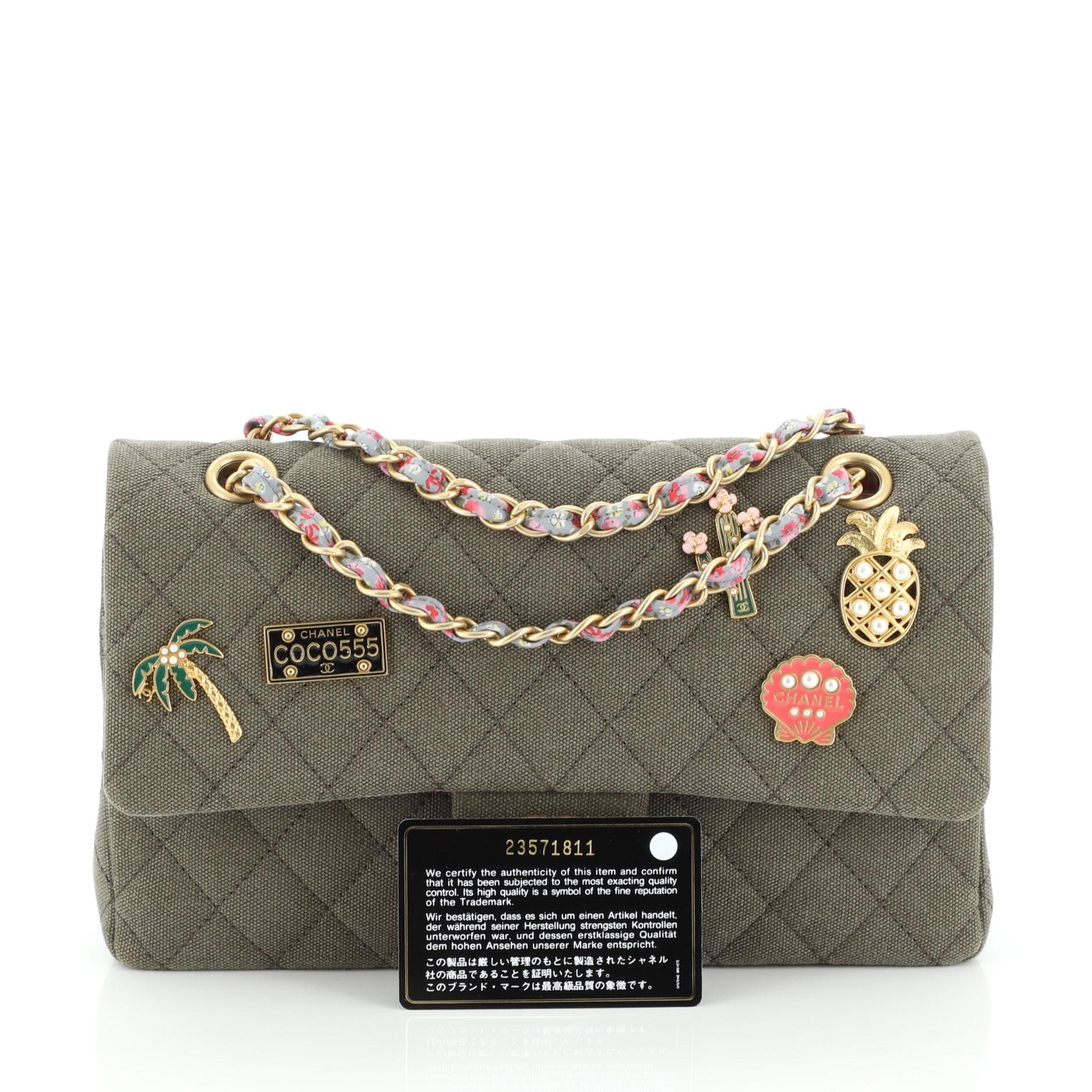 This Chanel Cuba Charms Classic Double Flap Bag Quilted Canvas Medium, crafted from green quilted canvas, features woven-in fabric chain strap, exterior back pocket, multicolor charms and gold-tone hardware. Its CC turn-lock closure opens to a