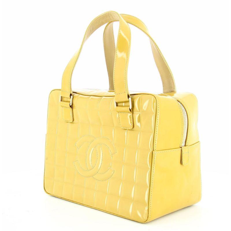 Chanel Gold patent leather cubic bag

Good condition, some parts has a lightly darker color due to the sun.
Serial number inside.
Packaging:  Opulence Vintage dust bag

Additional information:
Designer: Chanel 
Dimensions:  Height 20 cm / 8 