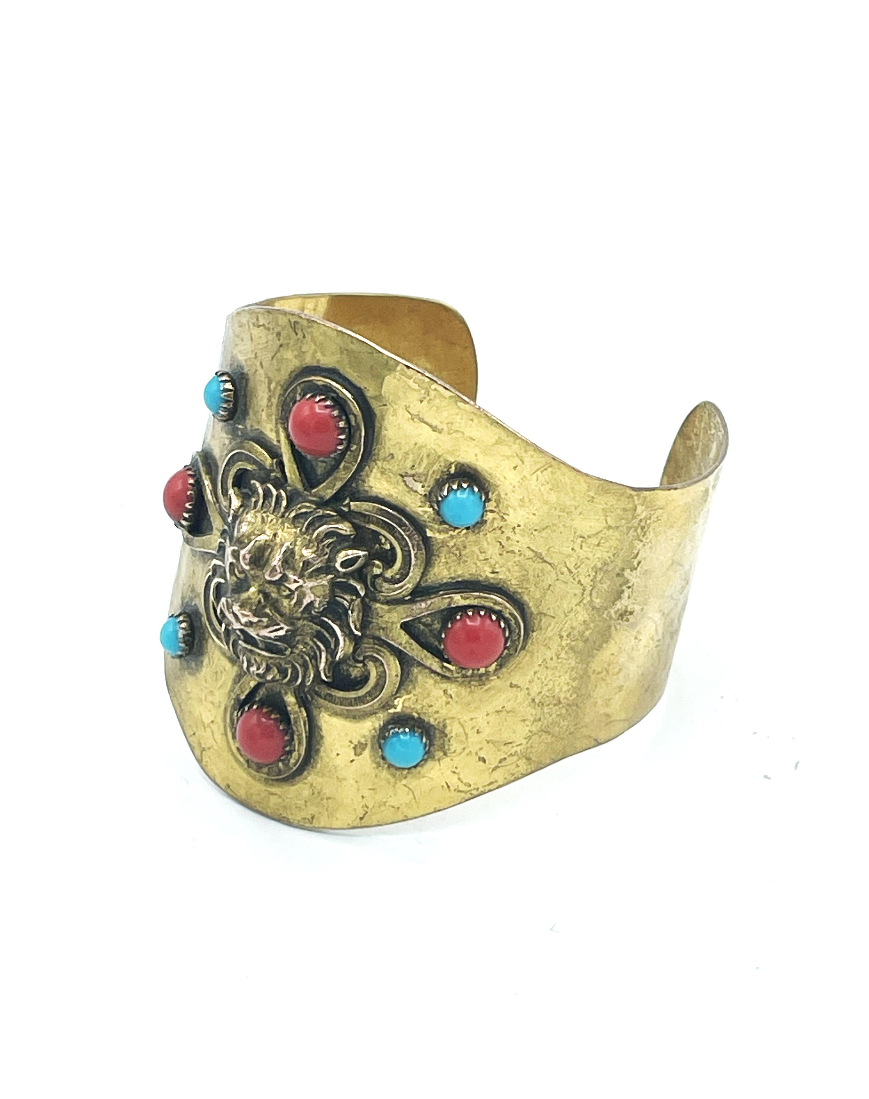 A georgeous CHANEL Cuff/bracelet  hammered gold plated metal with iconic lions and decoration, türkis and coral glass stones around the lion. This is a very early CHANEL  cuff/braselet from the time around 1965,  when Chanel reopened her boutique in