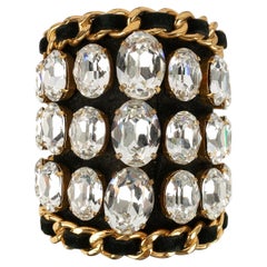 Bracciale Chanel in pelle nera e metallo dorato con strass