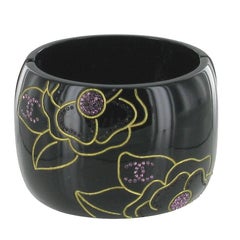 CHANEL Cuff Bracelet in Black resin with Golden Floral Pattern