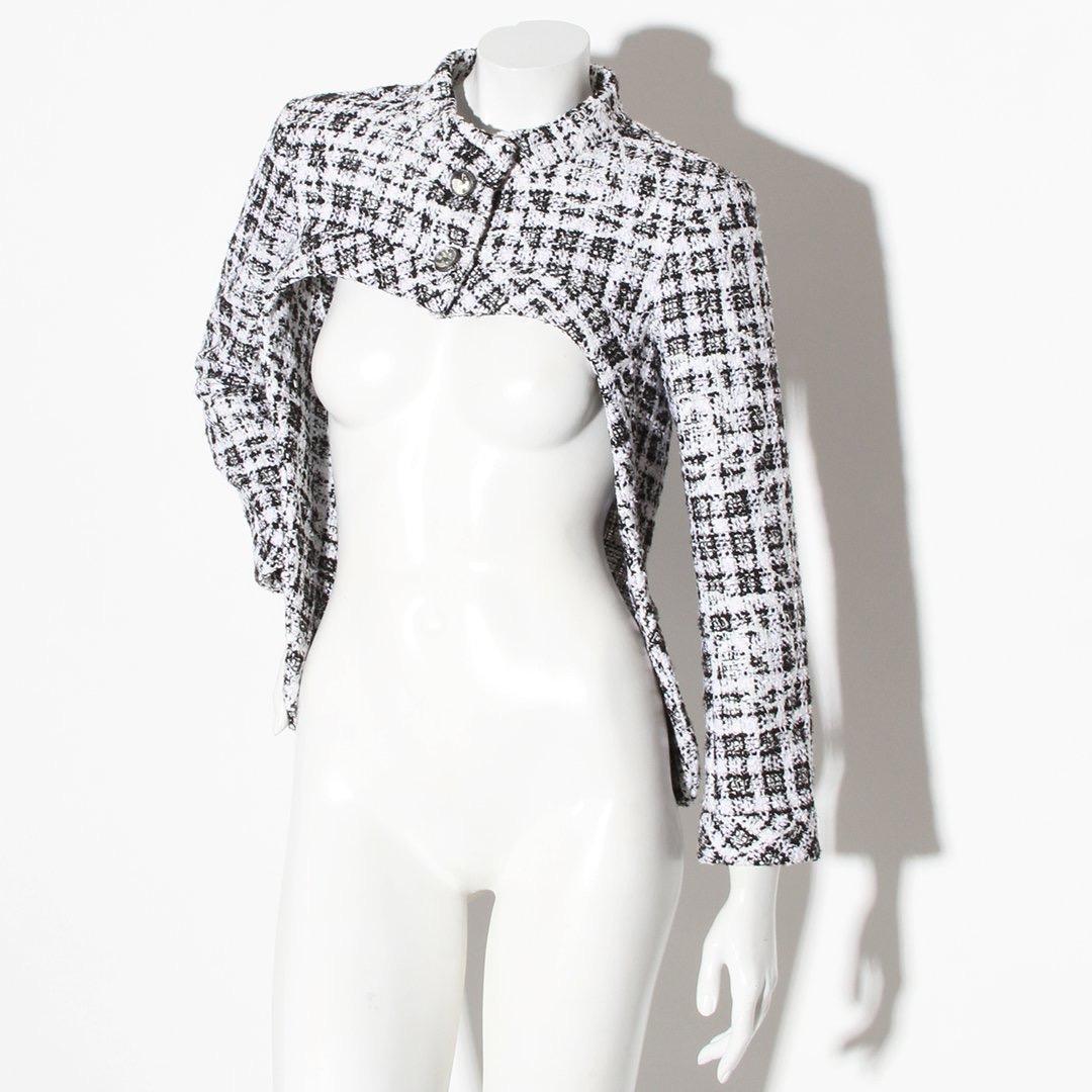 Cut out jacket by Chanel 
Spring/summer 2014 Collection 
Jacquard tweed 
Black and white 
High neck 
Button front closure
Cut out front at bust
Button cuff closure 
Clear buttons 
Silver tone metal hardware 
Silk lining
Condition: Excellent, brand