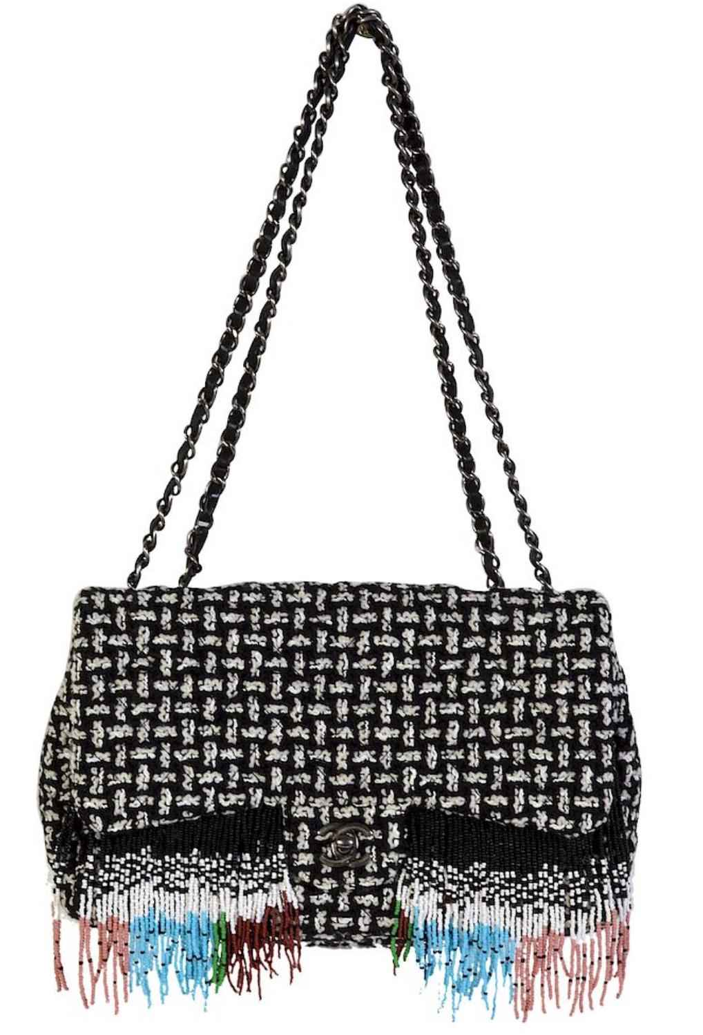 Chanel Dallas Metiers D'Art 2014 Tweed Fringe Rare Classic Flap 

Year: 2014

A unique classic flap bag in black and white tweed adorned with a multi-color seed bead fringe. The bag features a ruthenium chain strap and CC turnlock closure. It is