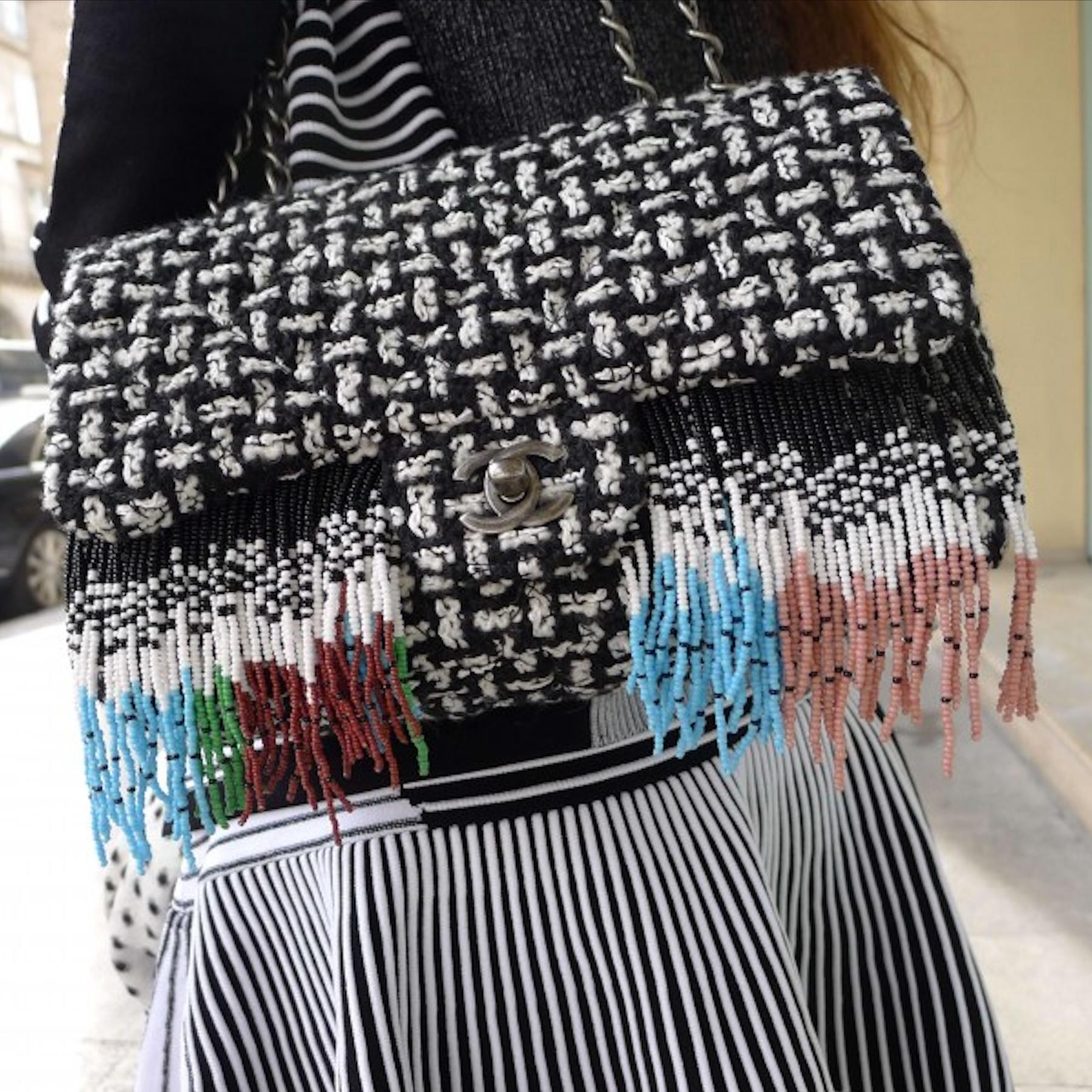 Chanel Dallas Metiers D'Art 2014 Tweed Fringe Rare Classic Flap 

Year: 2014

A unique classic flap bag in black and white tweed adorned with a multi-color seed bead fringe. The bag features a ruthenium chain strap and CC turnlock closure. It is