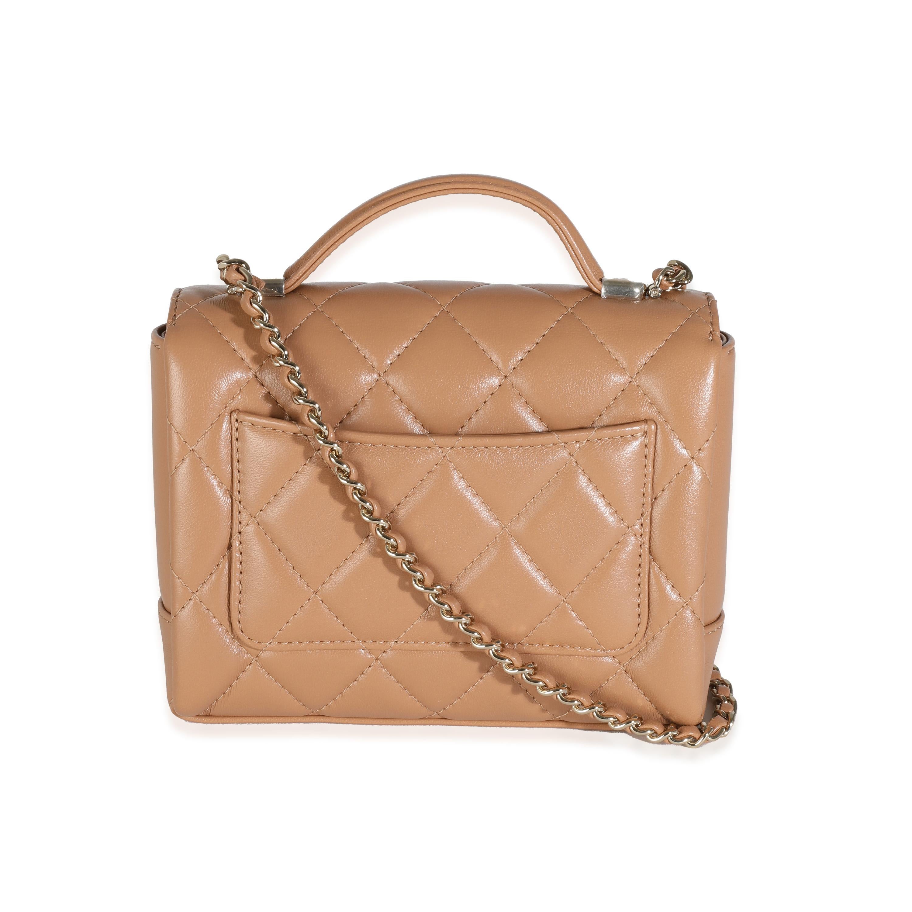 Listing Title: Chanel Dark Beige Quilted Lambskin Mini Flap With Top Handle
SKU: 144286
MSRP: 5700.00 USD
Condition: Pre-owned 
Condition Description: A timeless classic that never goes out of style, the flap bag from Chanel dates back to 1955 and