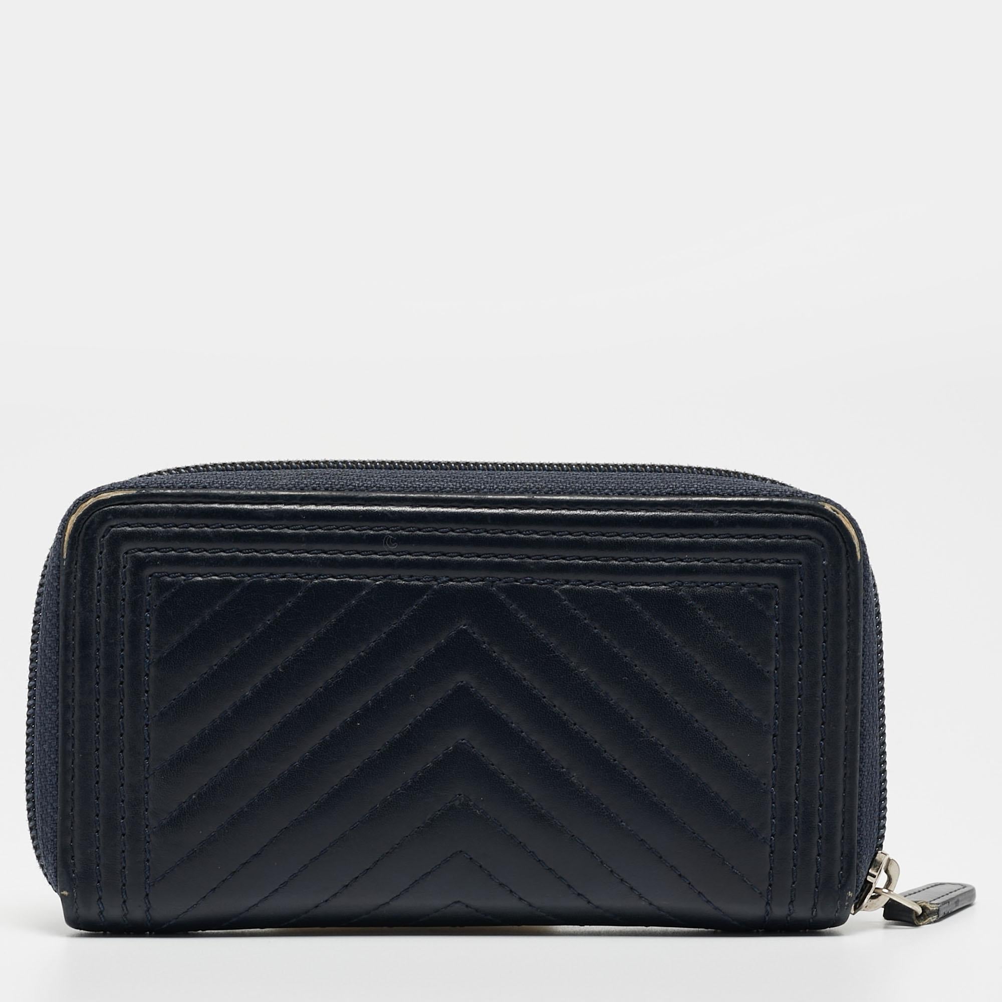 Every woman deserves to have a Chanel wallet in her collection. Crafted from chevron leather the bag features the iconic boy CC logo. The zip around wallet opens to a leather and nylon lined interior that houses compartments for currency and bills