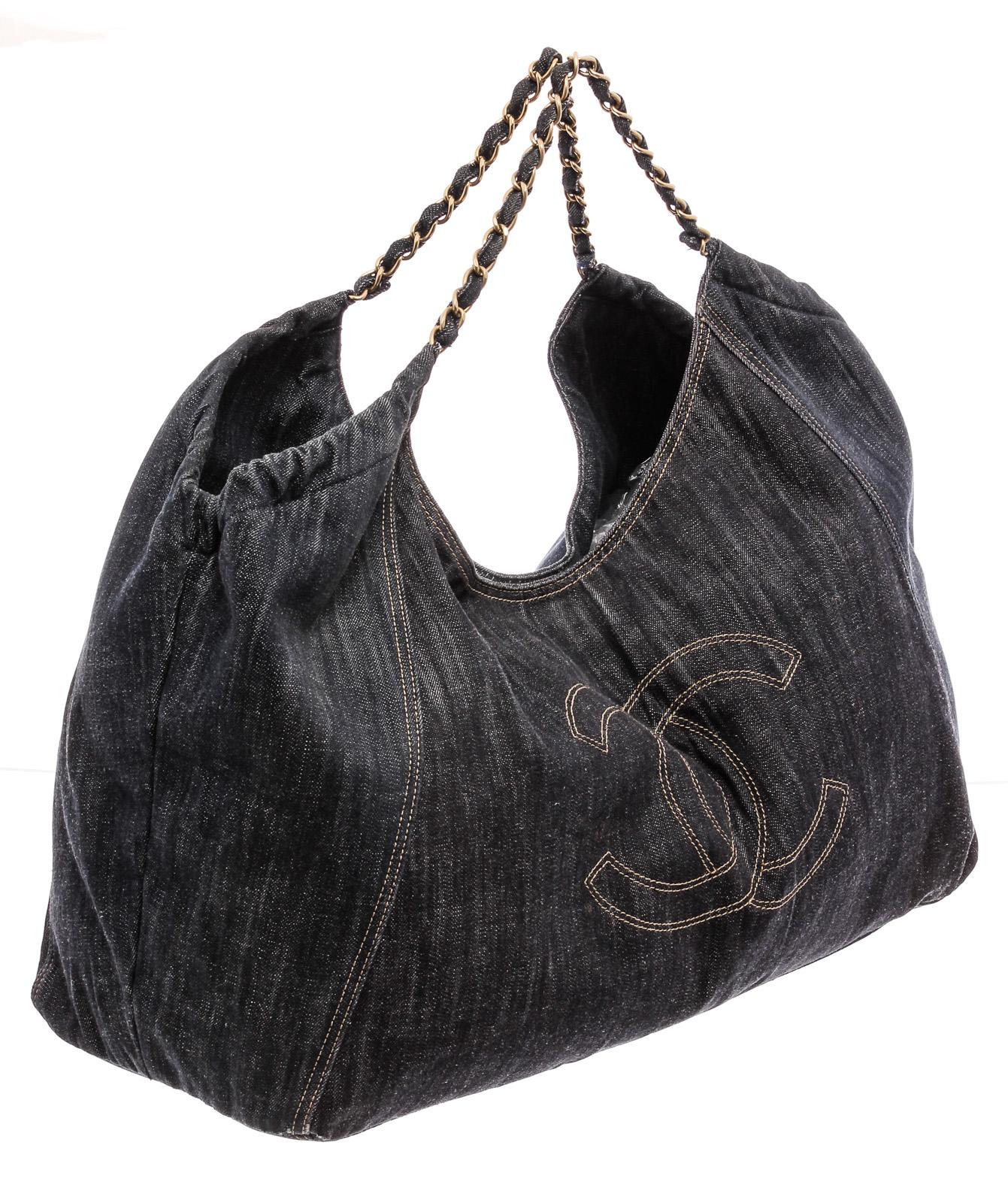 Dark wash blue denim Chanel XL Coco Cabas tote with brushed gold-tone hardware, dual chain-link and denim top handles, tan contrast stitching, stitched interlocking CC logo at front, tan logo jacquard lining, three pockets at interior wall; two