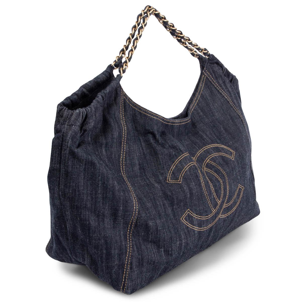 100% authentic Chanel Coco Cabas hobo shoulder bag in blue denim canvas and brushed gold-tone hardware with beige stitching details. Opens with a magnetic button on top and is lined in nude logo nylon with one big zipper pocket against the back and