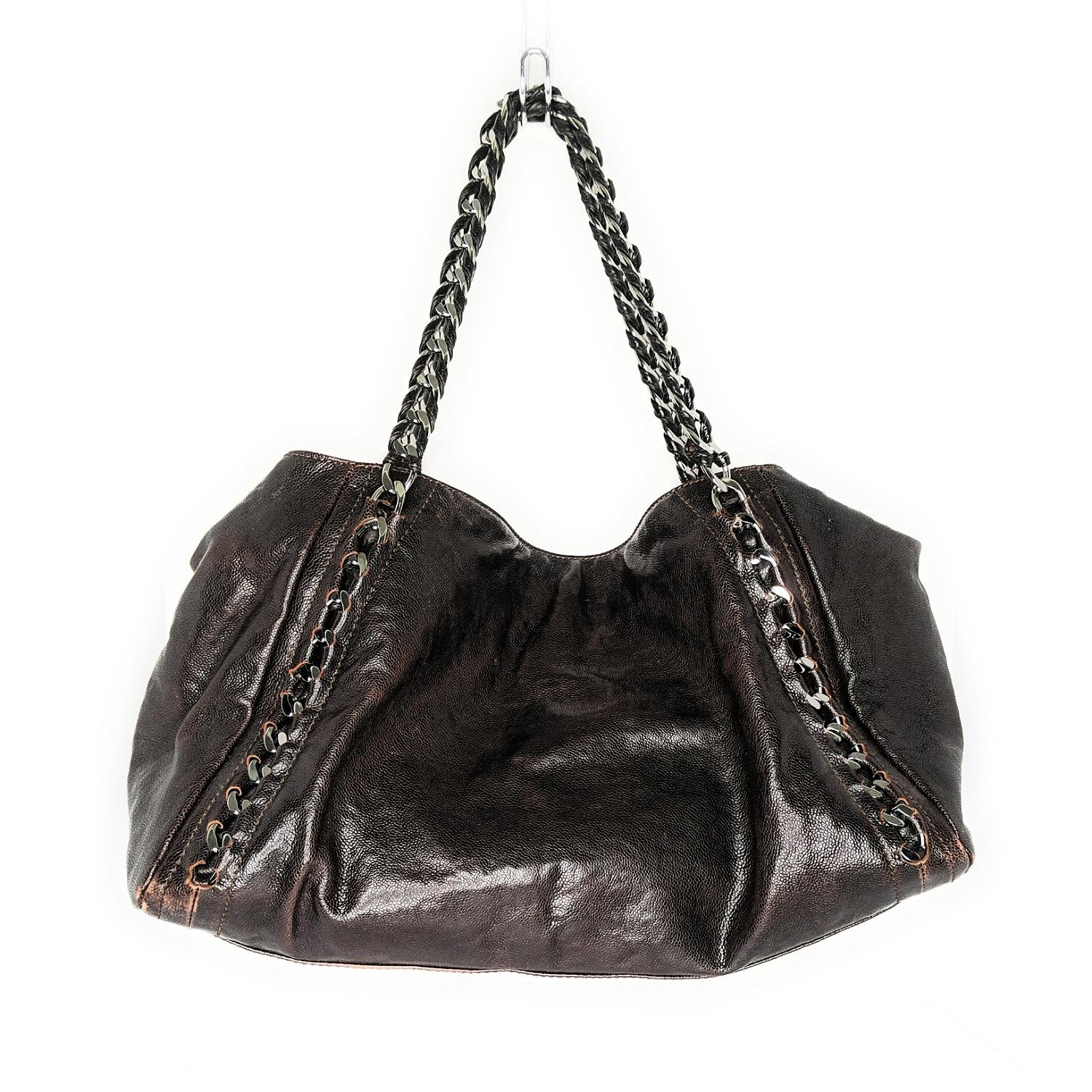 Diese brillante:: bequeme Kreation von Chanel ist etwas:: das Sie für immer bei sich tragen möchten. Diese dunkelbraune Chanel East West Tote Bag aus Kaviarleder verfügt über ein großes:: aufgenähtes CC-Logo und Kettengriffe aus Leder:: die an