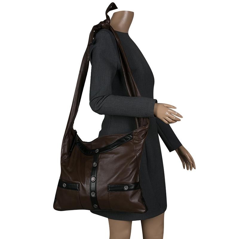Designed in the look of a beautiful and luxurious brown leather jacket, this Chanel Large Girl Chanel bag features black leather panels and black-tone button down detail at the front along with front pockets again detailed with buttons. With a