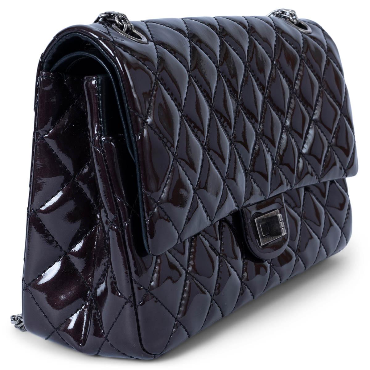 100% authentic Chanel 2.55 Reissue 226 double flap bag in dark brown patent leather featuring classic diamond quilted stitching and ruthenium hardware. Opens with a turn-lock to a black smooth calfskin interior with two patch pockets and one