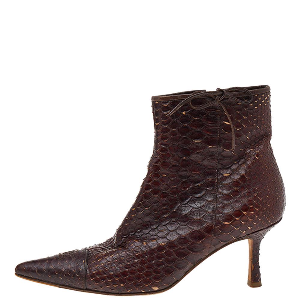 Add a high-end update to your look with these ankle boots from Chanel. Crafted from python leather, these brown designer ankle boots feature pointed toes and side zip closure. They are elevated on low heels and luxuriously lined for a comfort-laden