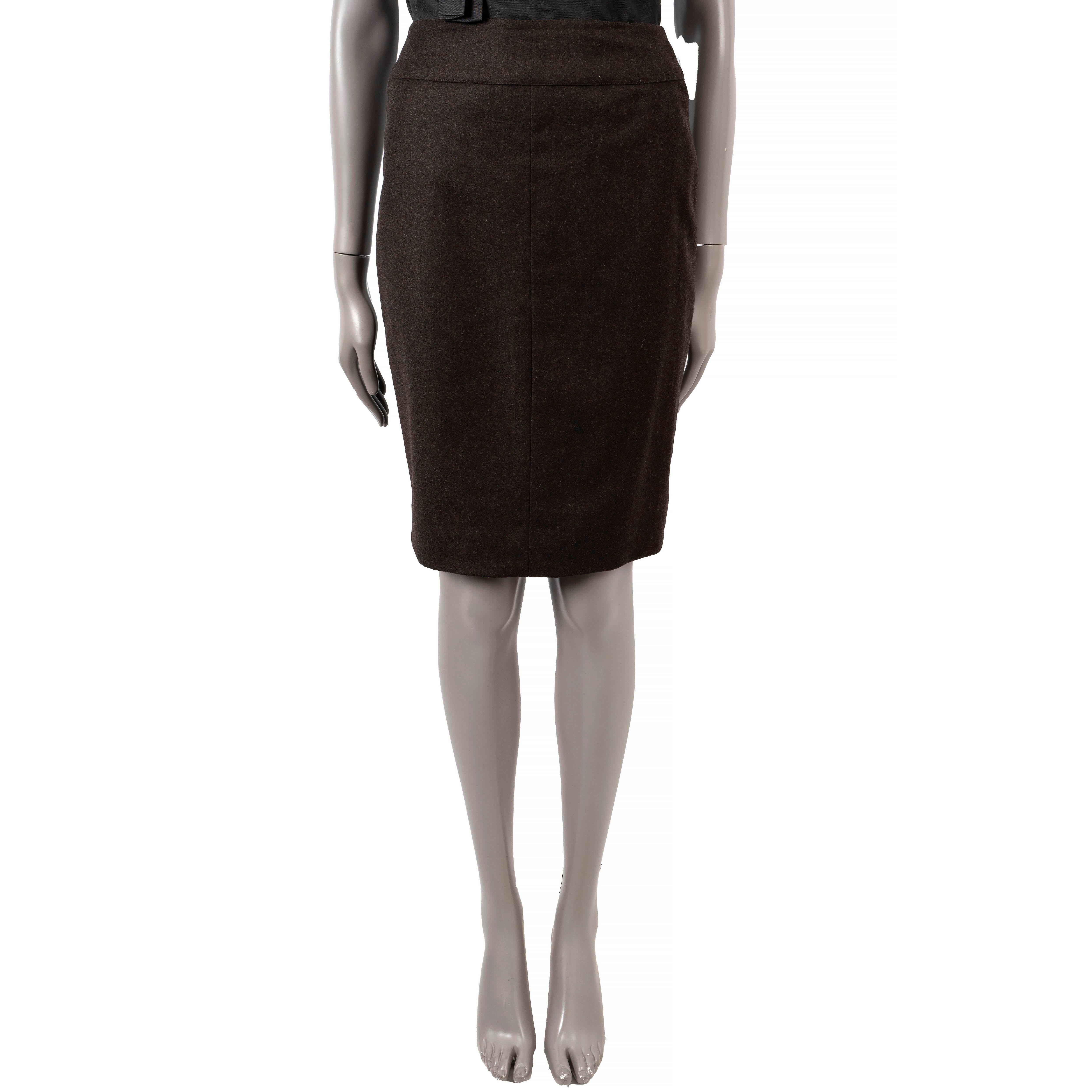 100% authentic Chanel knee length skirt in dark brown (with 10% cashmere) with golden zipper detail on the front. Opens with hidden zipper and two buttons on the front. Lined in silk (100%). Has been worn and is in excellent condition.

1999