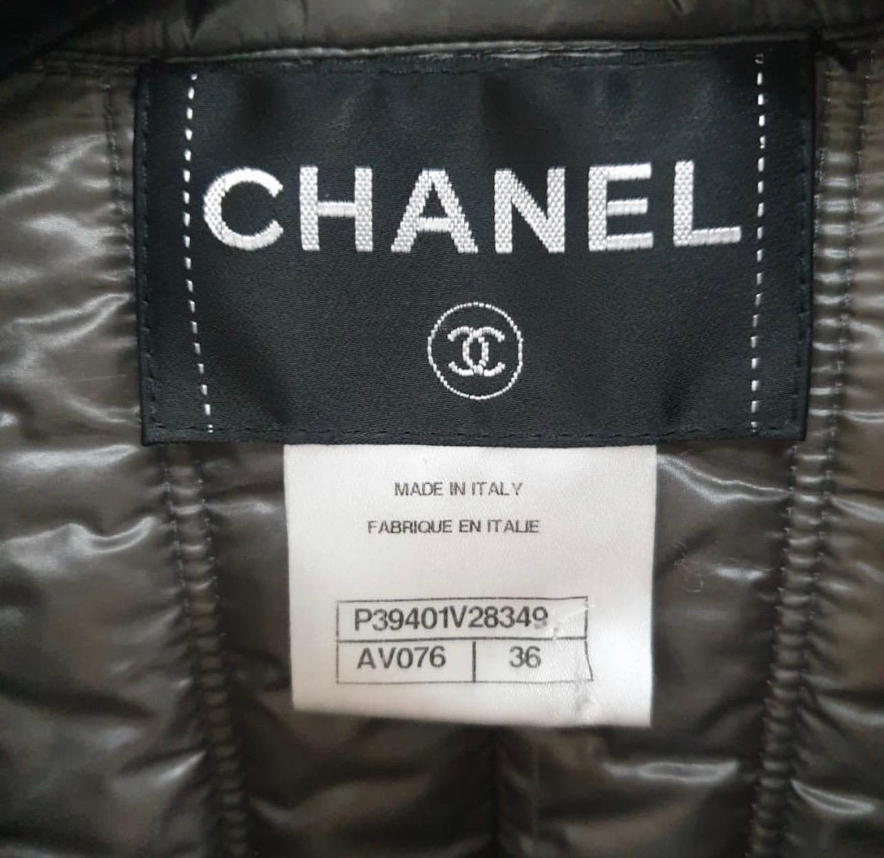 From the Fall 2010 Collection. 
Dark grey Chanel quilted puffer jacket with stand collar, rib knit trim, dual slit pockets at sides with logo-embellished buttons and exposed zip closure at center front. 
Sz.36
Very good condition.
Hanger is not